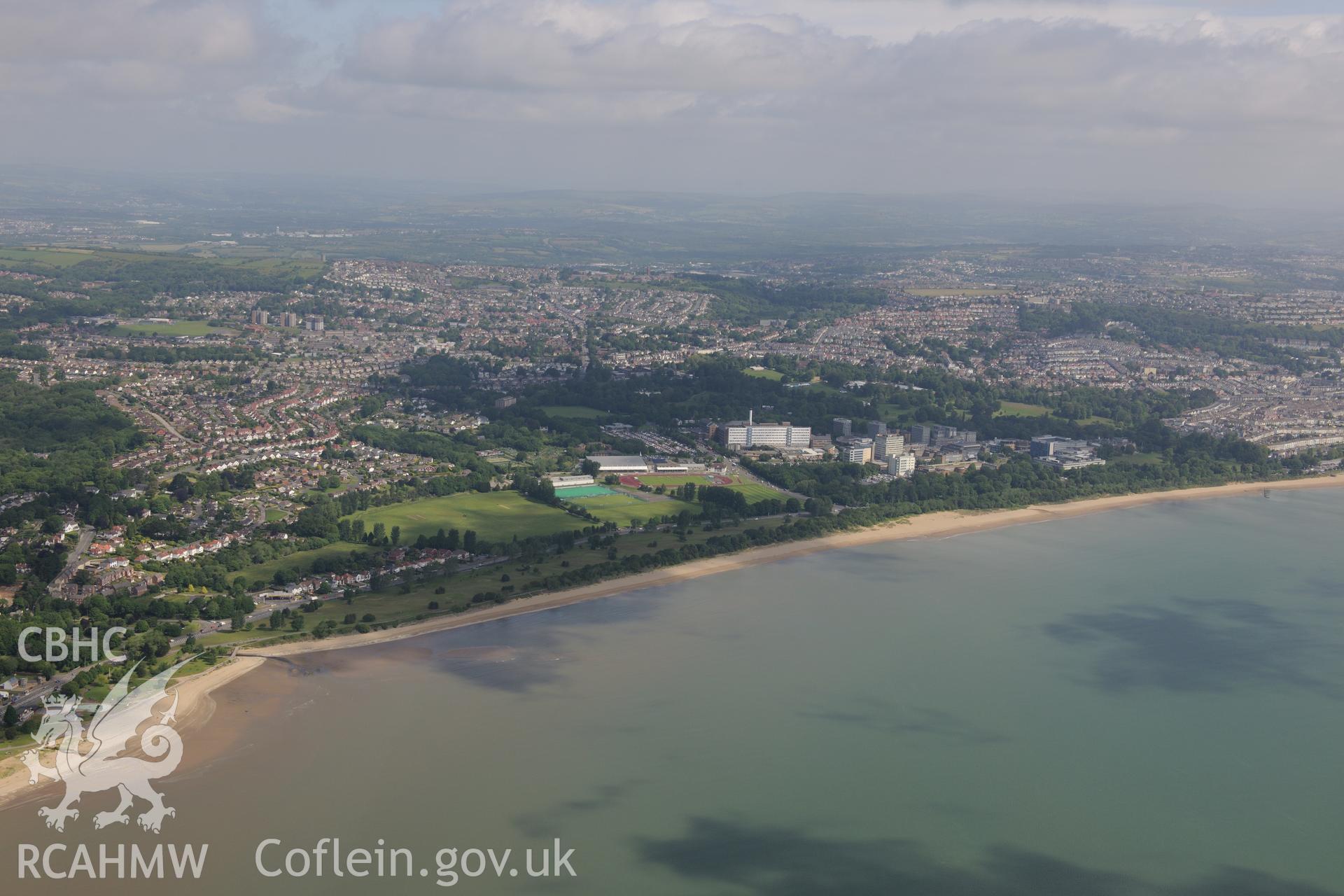 Views of Swansea University, King George V playing field and Singleton Hospital, taken from Swansea Bay. Oblique aerial photograph taken during the Royal Commission's programme of archaeological aerial reconnaissance by Toby Driver on 19th June 2015.