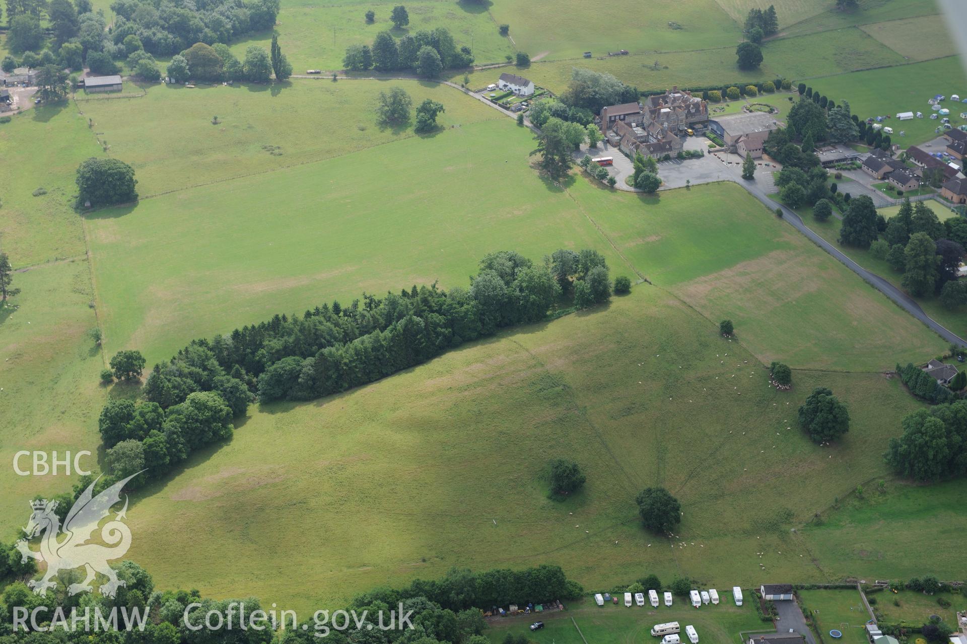 Grounds and gardens of Gwernyfed Park (including the former deer park); Gwernyfed Gaer defended enclosure, and Gwernyfed High School. Oblique aerial photograph taken during the Royal Commission?s programme of archaeological aerial reconnaissance by Toby Driver on 1st August 2013.