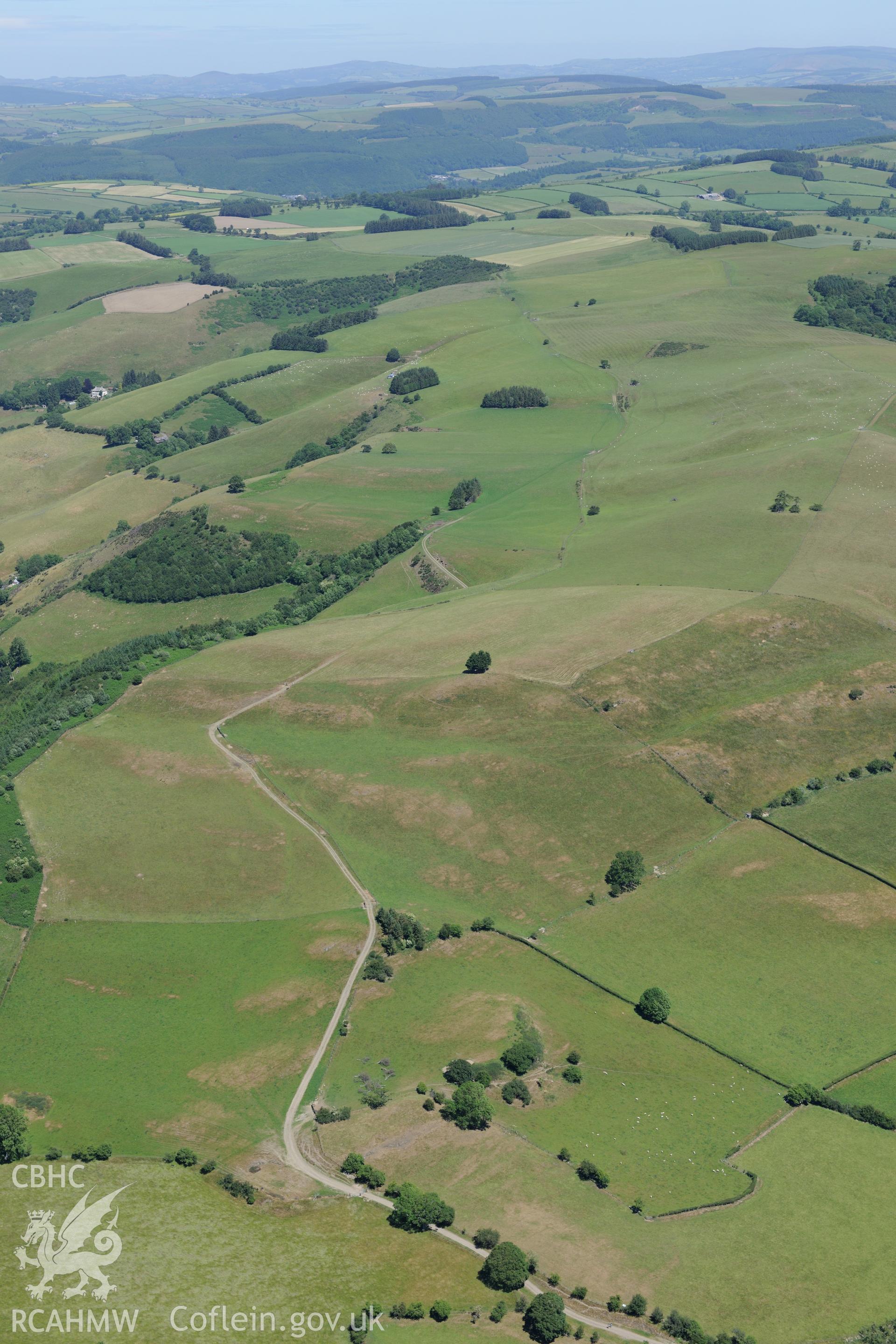 Section of Offa's Dyke 1125 metres south west to Gilfach Wood, north east of Presteigne. Oblique aerial photograph taken during the Royal Commission's programme of archaeological aerial reconnaissance by Toby Driver on 30th June 2015.