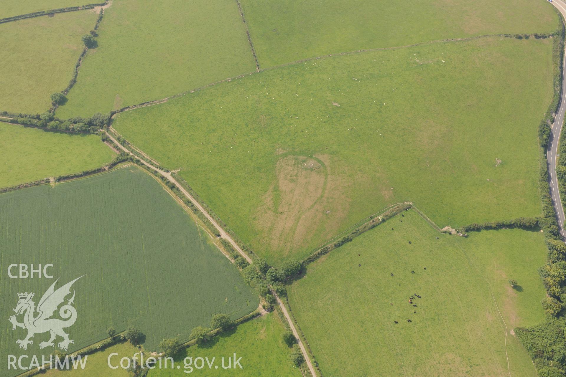 Enclosures at Pant-Teg, on the southern outskirts of Aberaeron. Oblique aerial photograph taken during the Royal Commission?s programme of archaeological aerial reconnaissance by Toby Driver on 12th July 2013.