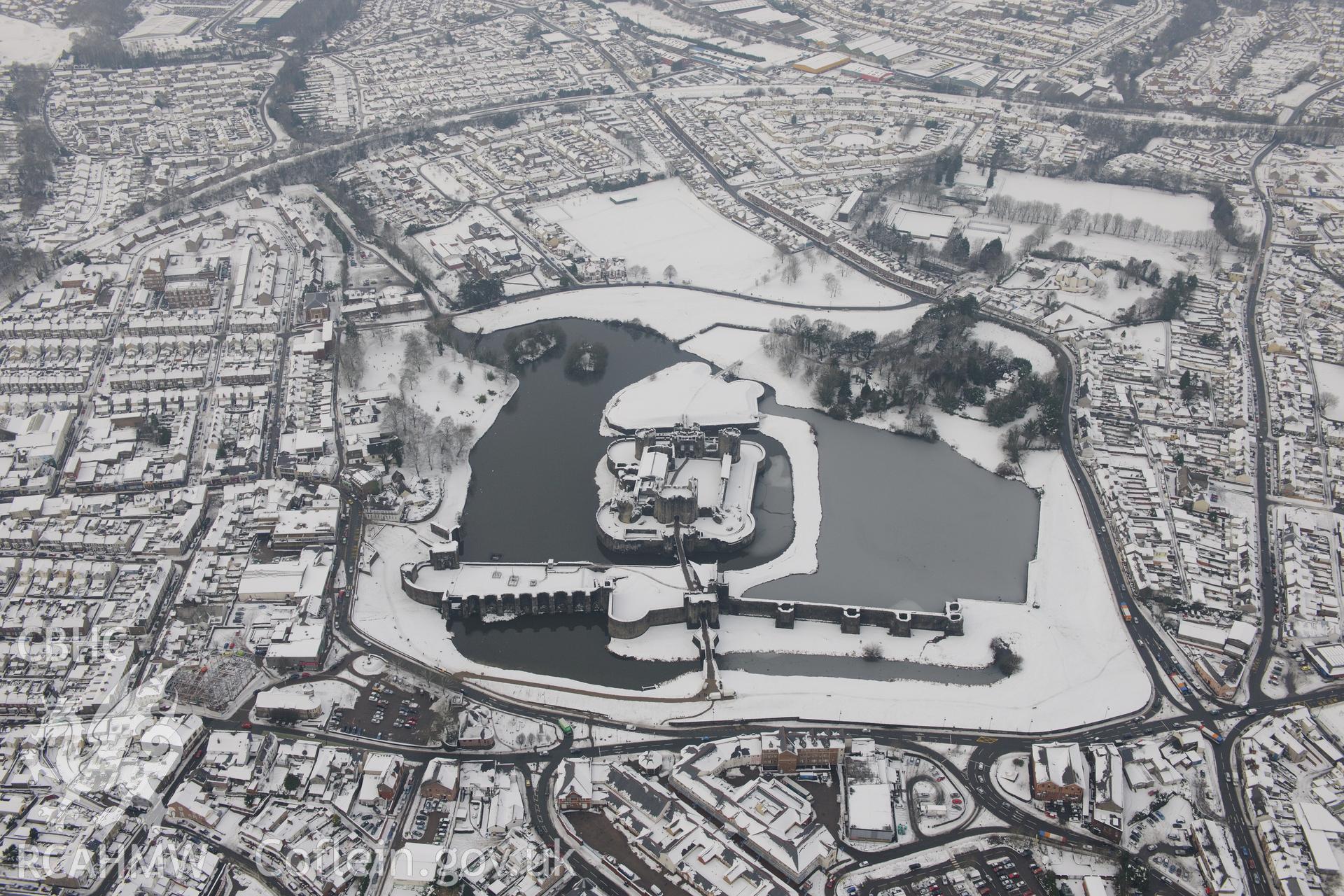 Caerphilly Castle and the town of Caerphilly. Oblique aerial photograph taken during the Royal Commission?s programme of archaeological aerial reconnaissance by Toby Driver on 24th January 2013.