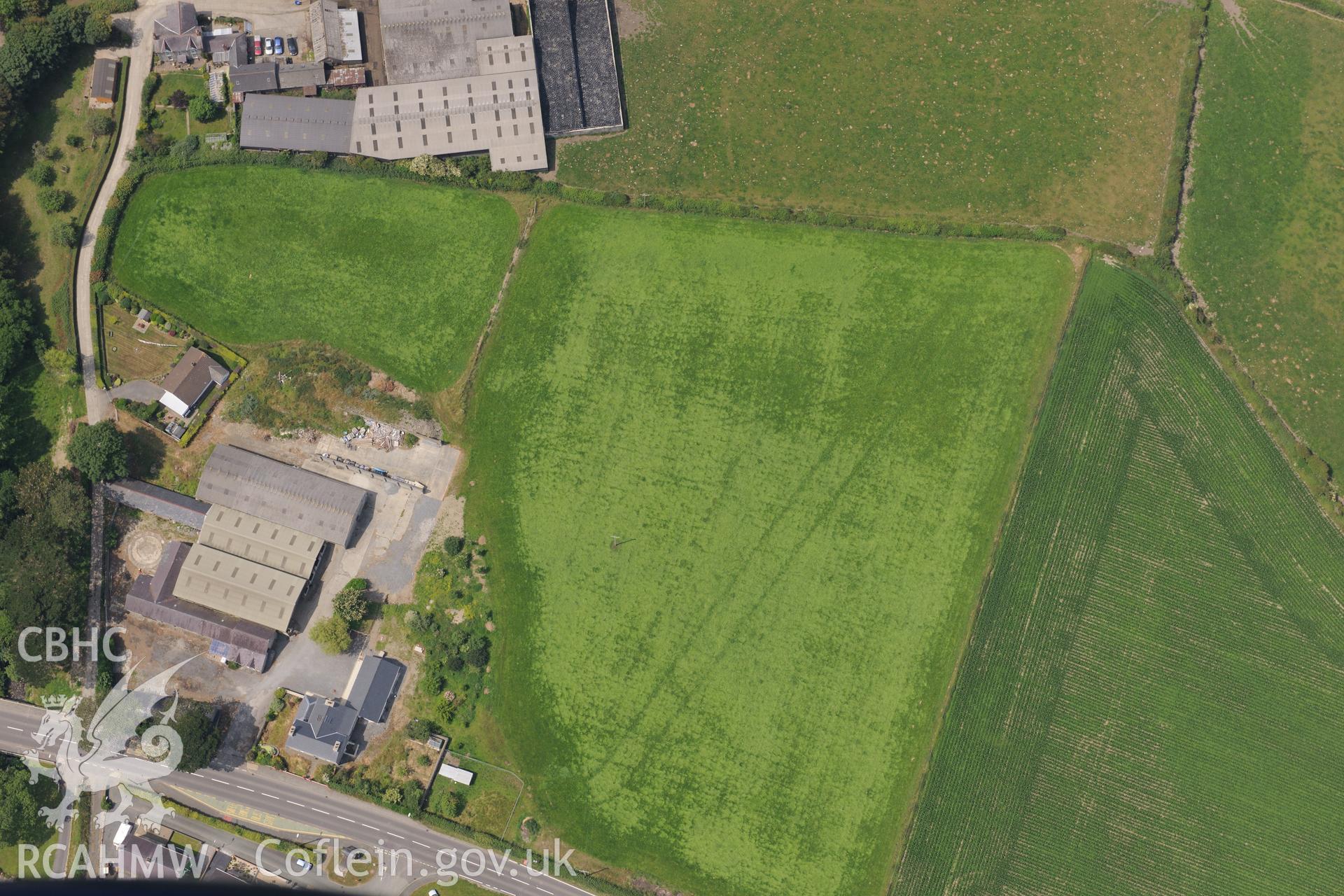 Double ditches at Penlon Farm, Llanon, Aberystwyth. Oblique aerial photograph taken during the Royal Commission?s programme of archaeological aerial reconnaissance by Toby Driver on 12th July 2013.