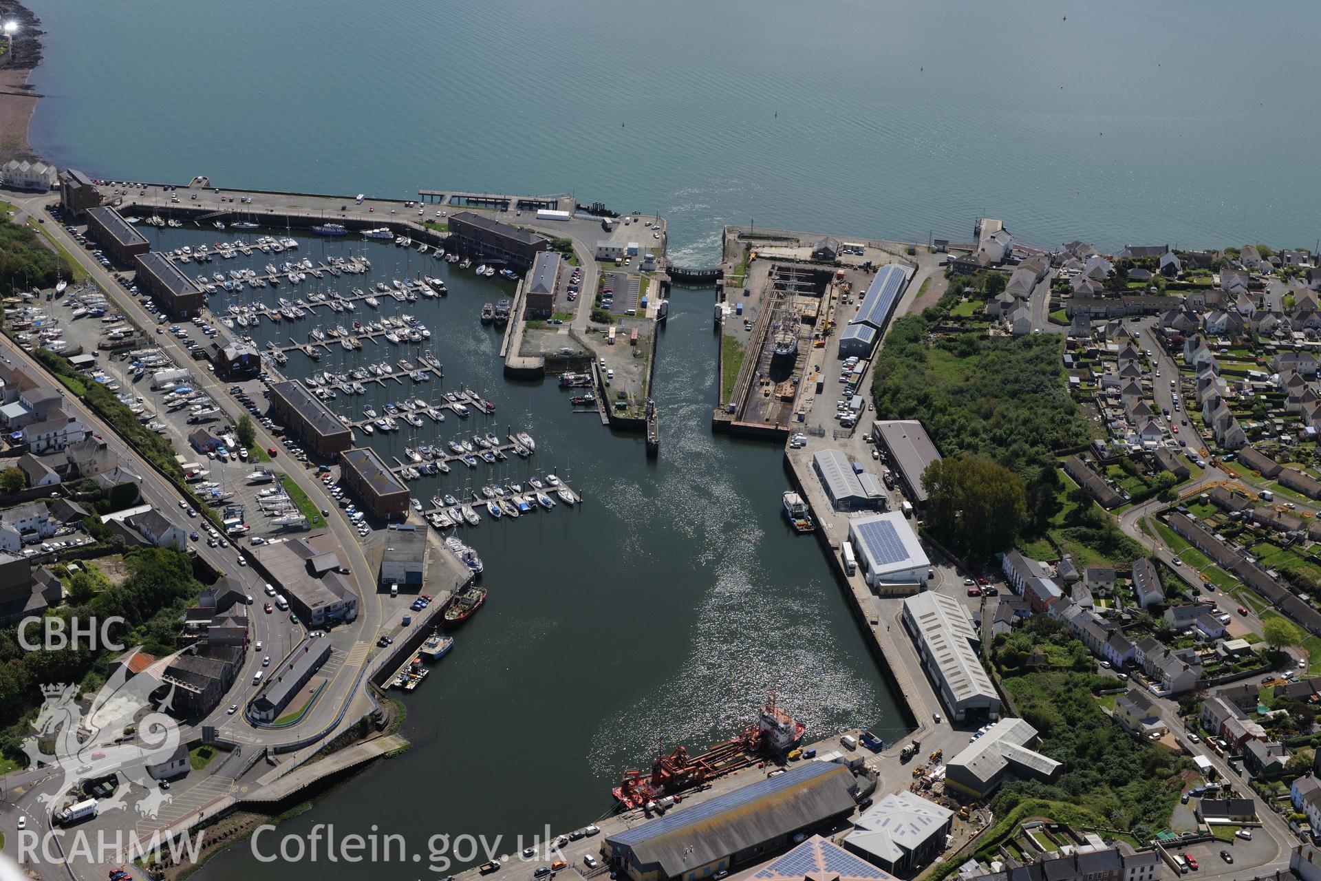Milford Haven Dockyard at Milford Haven Docks. Oblique aerial photograph taken during the Royal Commission's programme of archaeological aerial reconnaissance by Toby Driver on 13th May 2015.