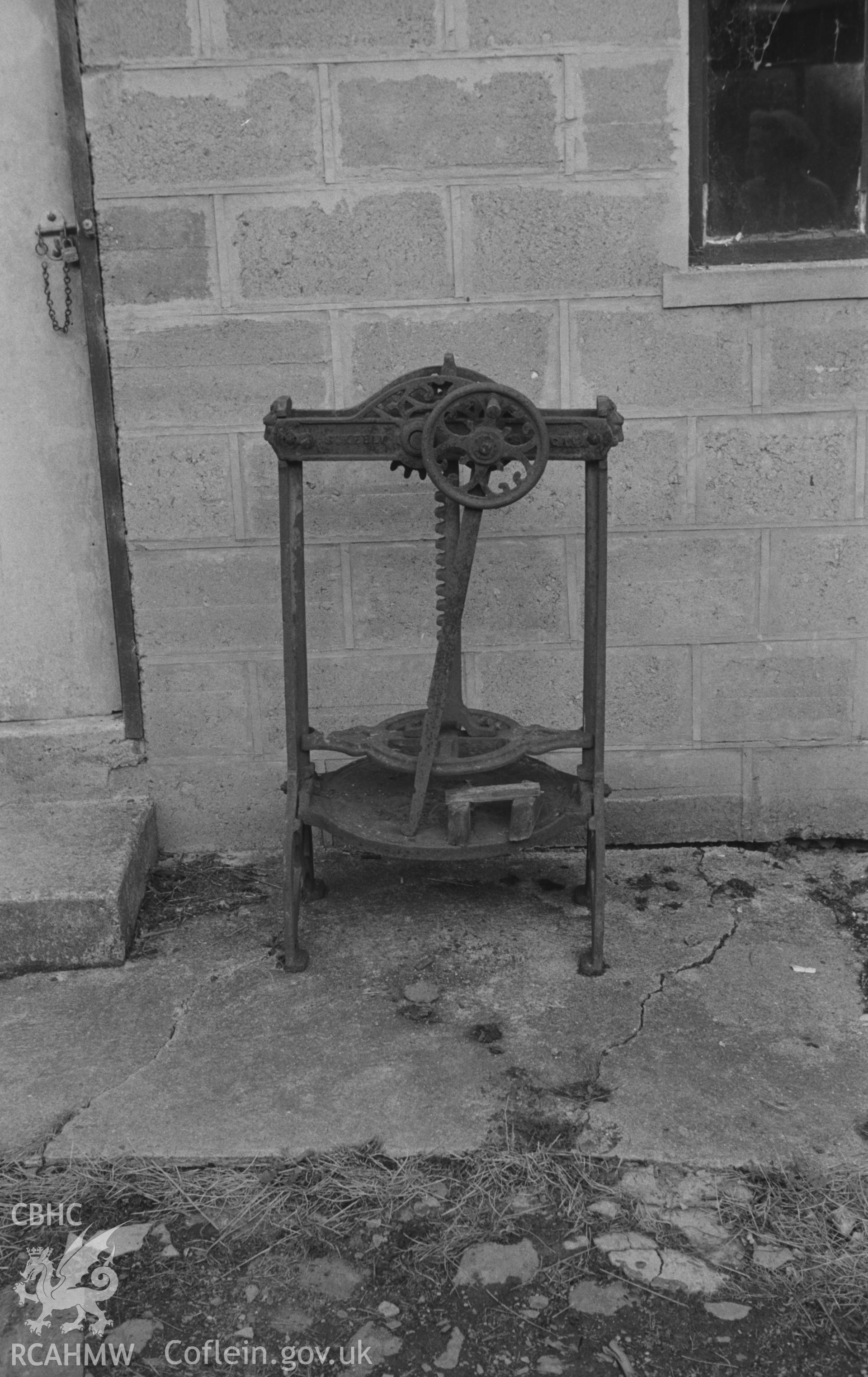 Digital copy of a black and white negative showing cast iron press in the yard of Felin Pen-yr-Allt, Nant Arberth. Photographed by Arthur O. Chater on 11th September 1964 from Grid Reference SN 2211 4429.