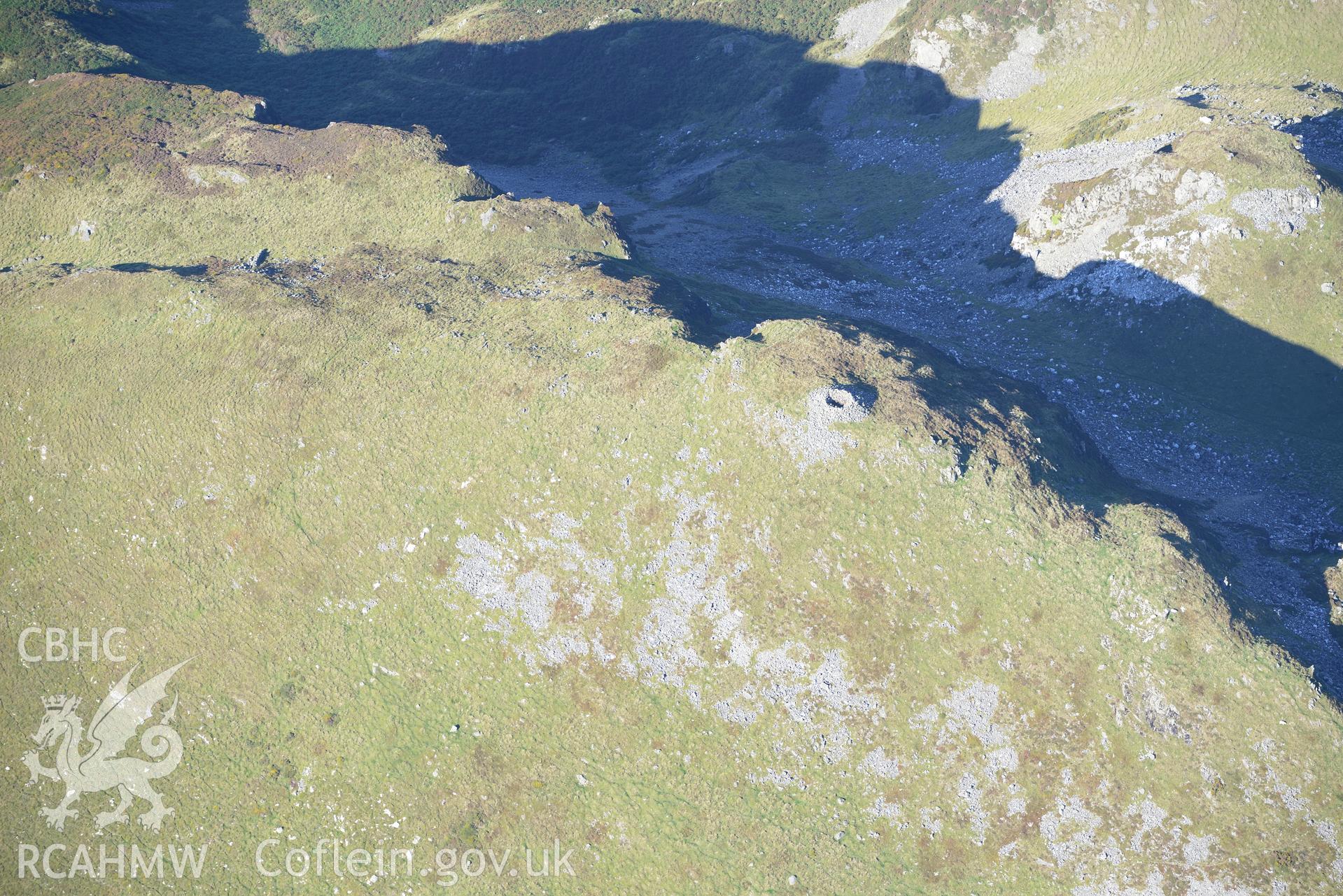 Craig yr Aderyn cairn, and a crag to its east, near Abergynolwyn. Oblique aerial photograph taken during the Royal Commission's programme of archaeological aerial reconnaissance by Toby Driver on 2nd October 2015.