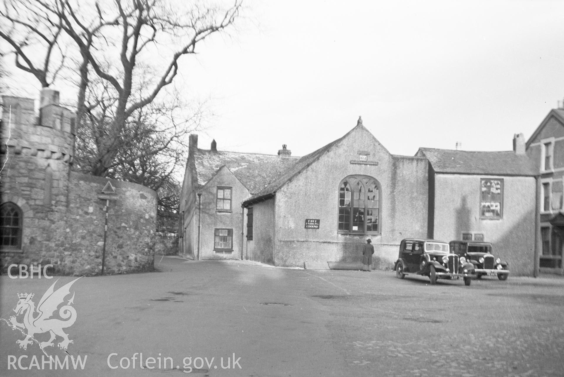 Digital copy of a nitrate negative showing exterior of Beaumaris Gaol with two early twentieth-century cars in front. From the Cadw Monuments in Care Collection.