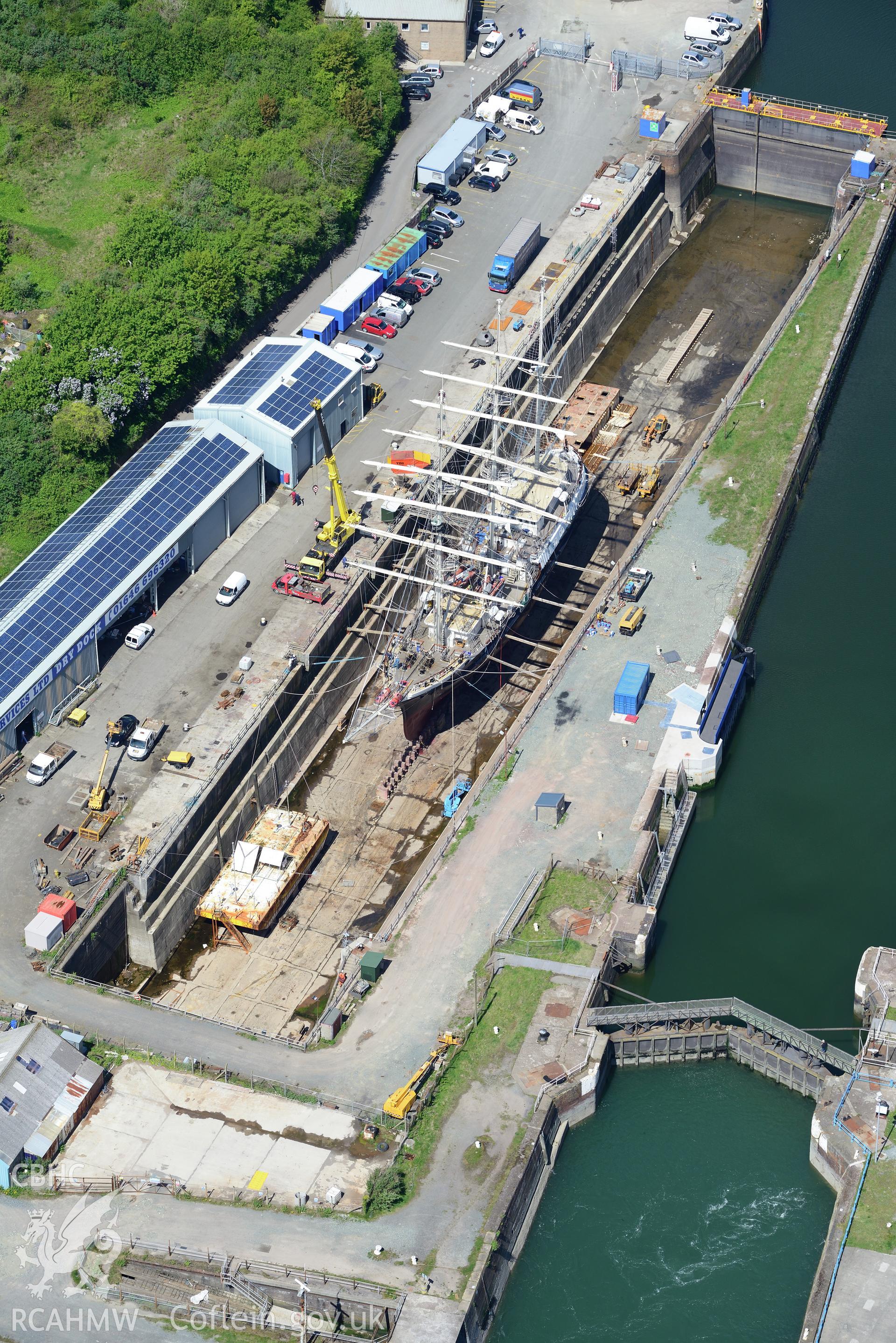 Milford Haven Docks. Oblique aerial photograph taken during the Royal Commission's programme of archaeological aerial reconnaissance by Toby Driver on 13th May 2015.