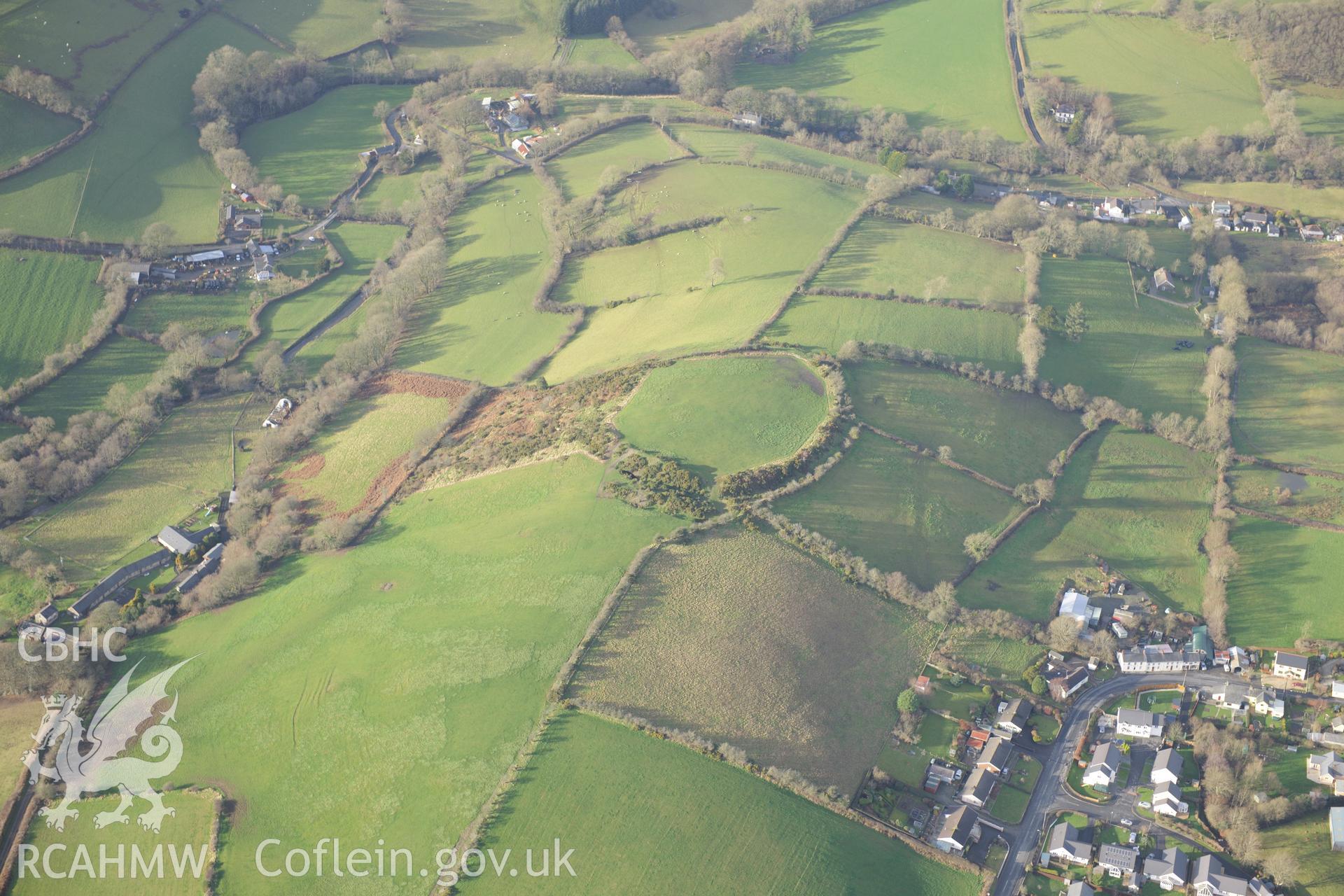 Cribyn village and Gaer Maesmynach hill fort. Oblique aerial photograph taken during the Royal Commission's programme of archaeological aerial reconnaissance by Toby Driver on 6th January 2015.