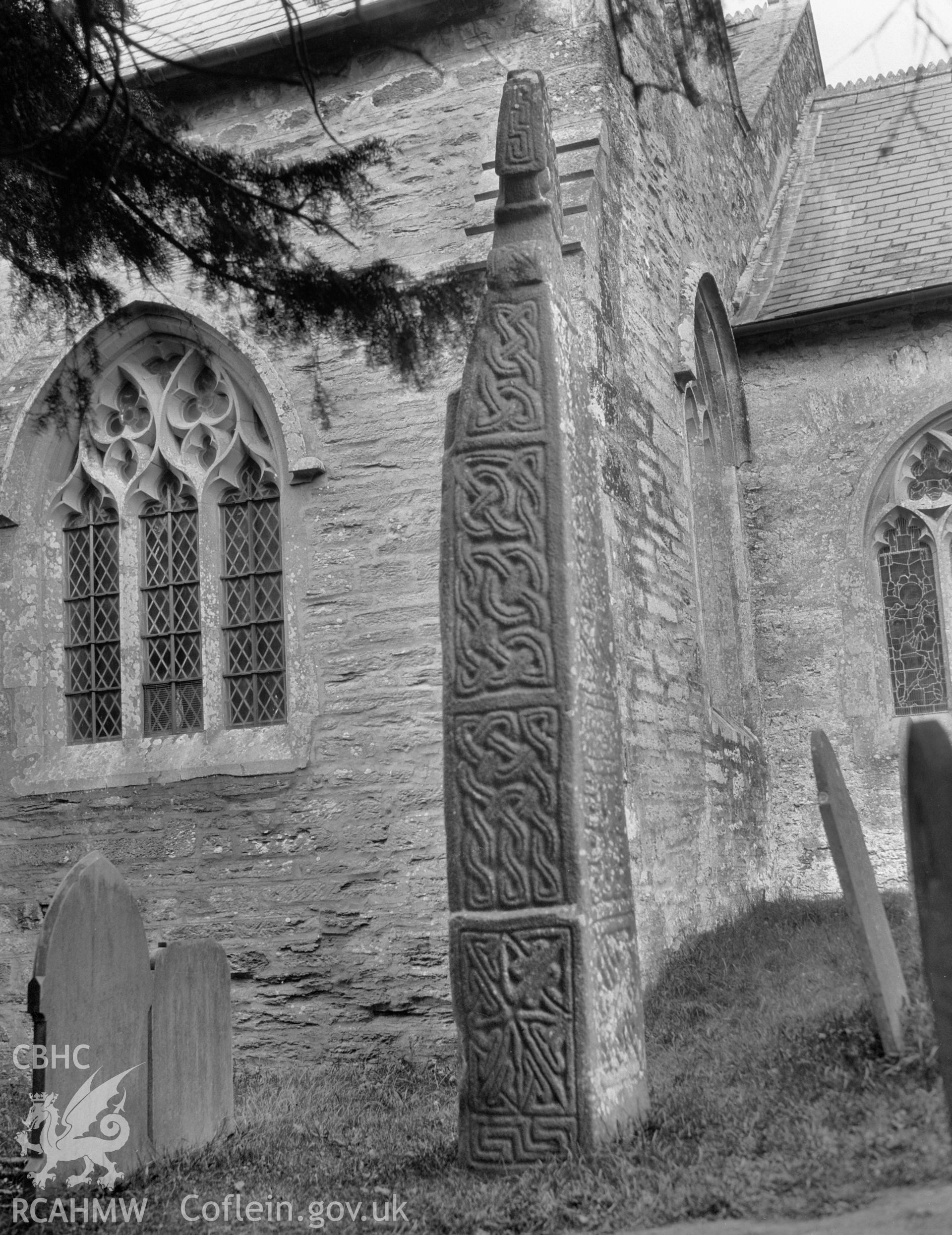 Digital copy of a nitrate negative showing the south face of St Brynach's Cross in the churchyard of St Brynach's Church, Nevern. From the National Building Record Postcard Collection.