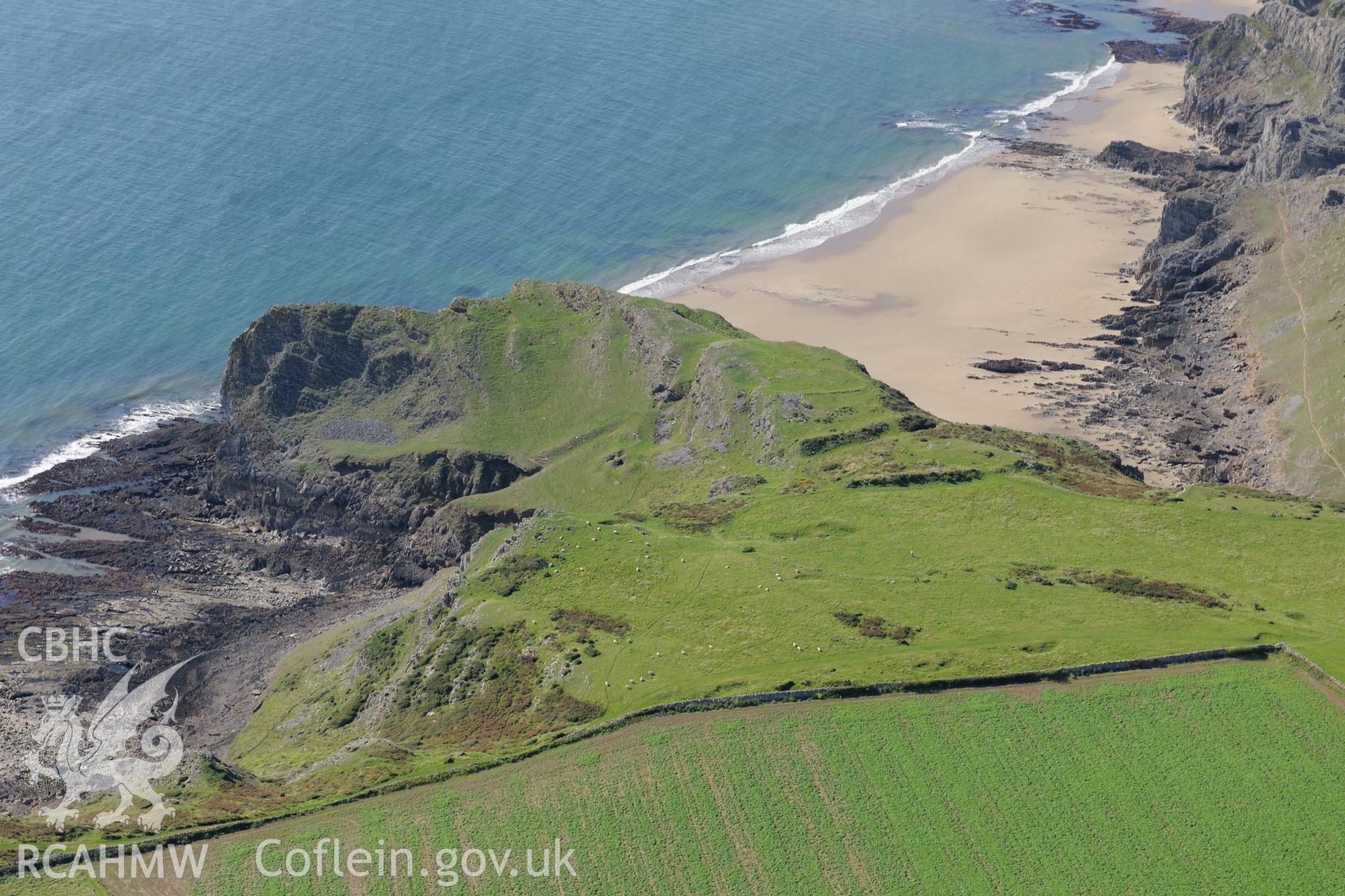 Thurba Camp defended enclosure, south of Rhossili, on the south western coast of the Gower Peninsula. Oblique aerial photograph taken during the Royal Commission's programme of archaeological aerial reconnaissance by Toby Driver on 30th September 2015.