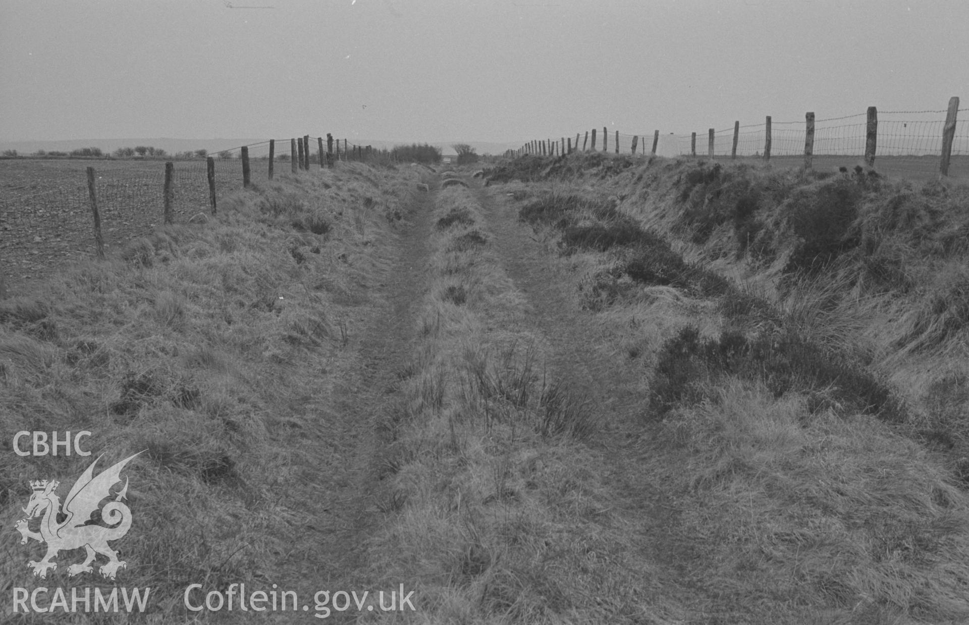 Digital copy of a black and white negative showing view looking along the hilltop track from near the 1021 traingulation point on Whilgarn. Photographed by Arthur O. Chater in April 1967 looking west south west from SN 451 518.