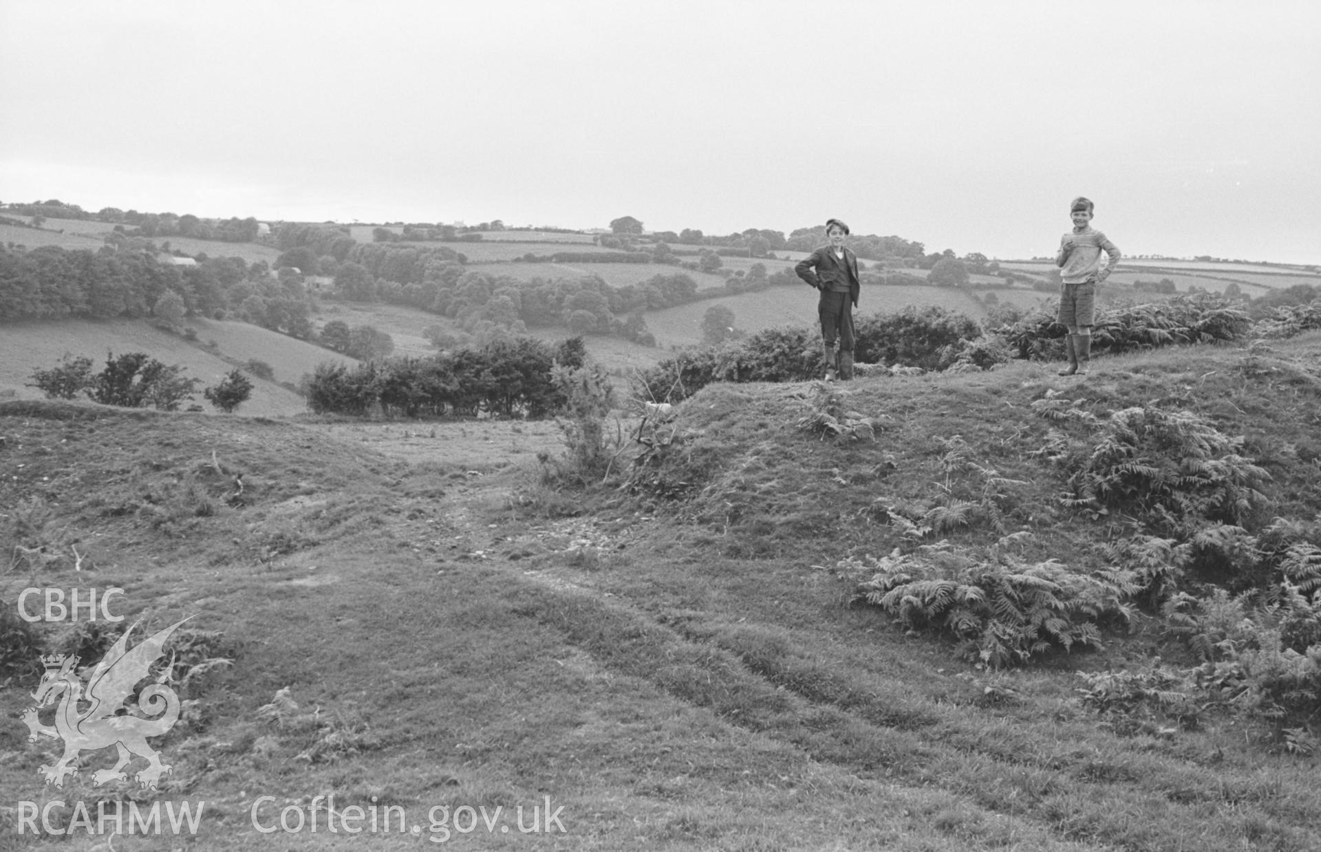 Digital copy of black & white negative showing entrance (modern?) at south eastern corner of ramparts of iron age camp by Blaen-igau; Brynhoffnant 1.3km away on skyline to right of centre. Photographed in August 1963 by Arthur O. Chater from SN 3421 5060.