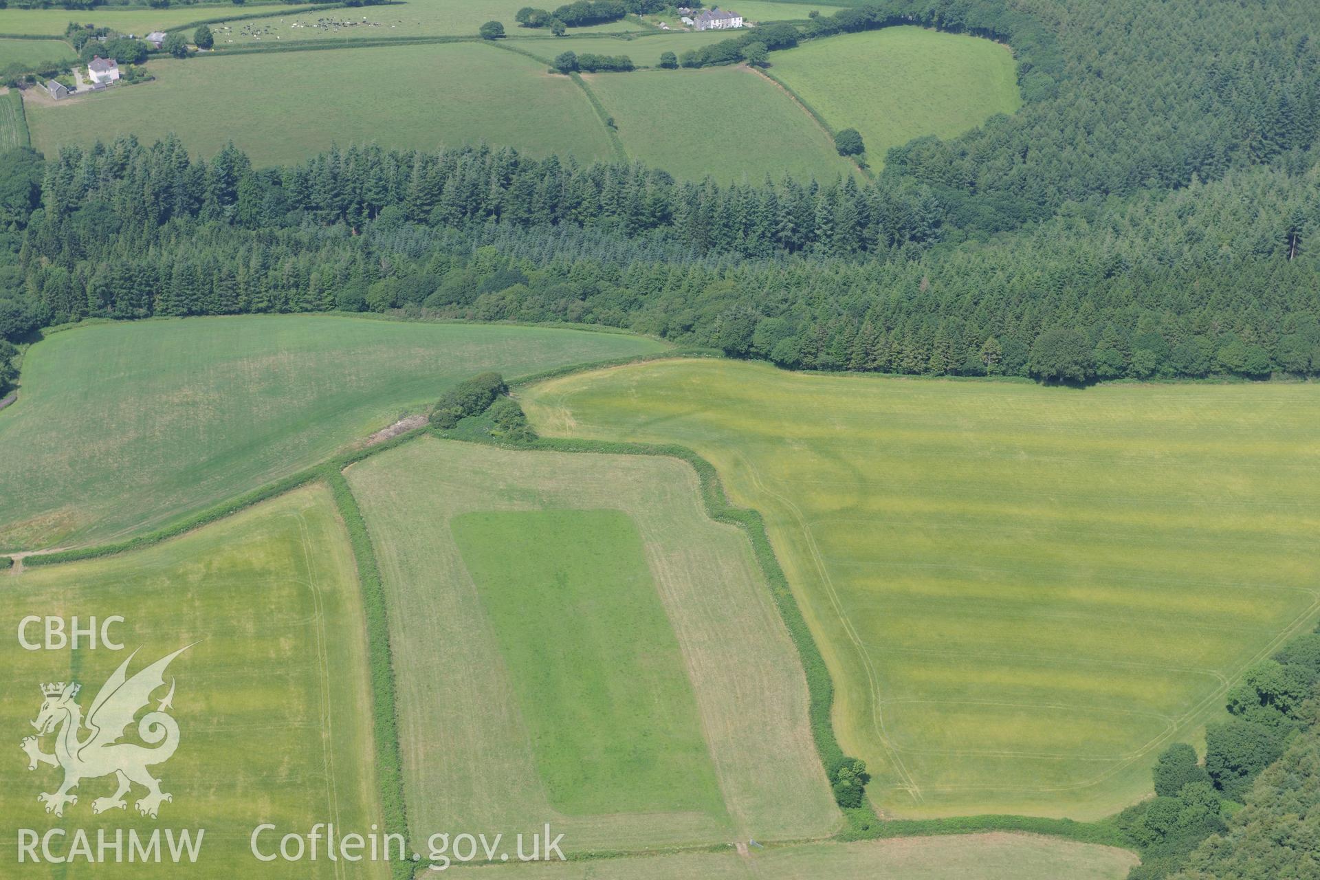 Woodside Camp Enclosure, north of Narberth. Oblique aerial photograph taken during the Royal Commission?s programme of archaeological aerial reconnaissance by Toby Driver on 16th July 2013.