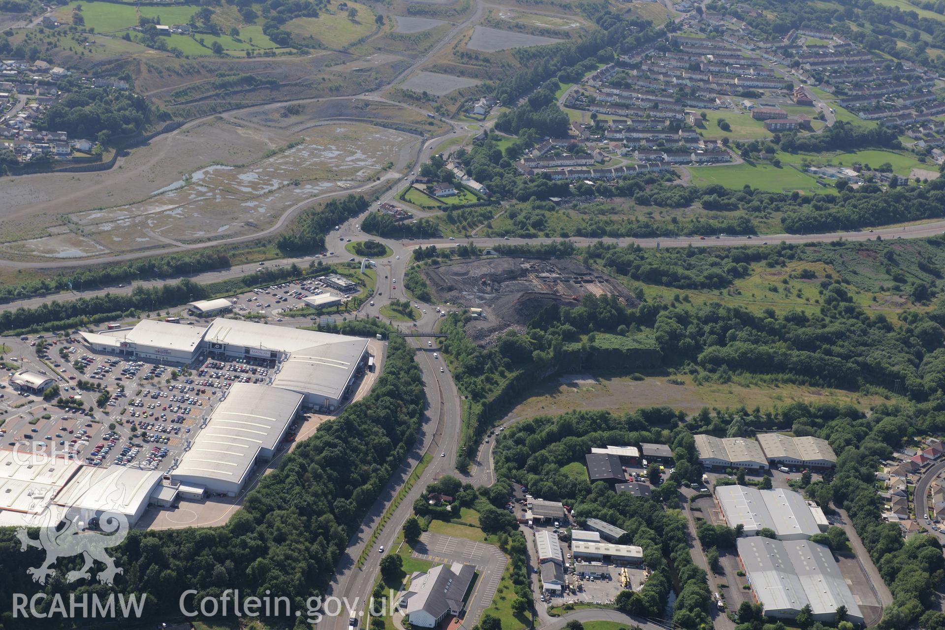 Site of former Rotax factory, Cyfarthfa Retail Park, and Cyfarthfa Ironworks including the remains of its blast furnaces, under excavation by Glamorgan-Gwent Archaeological Trust. Oblique aerial photograph taken during the Royal Commission?s programme of