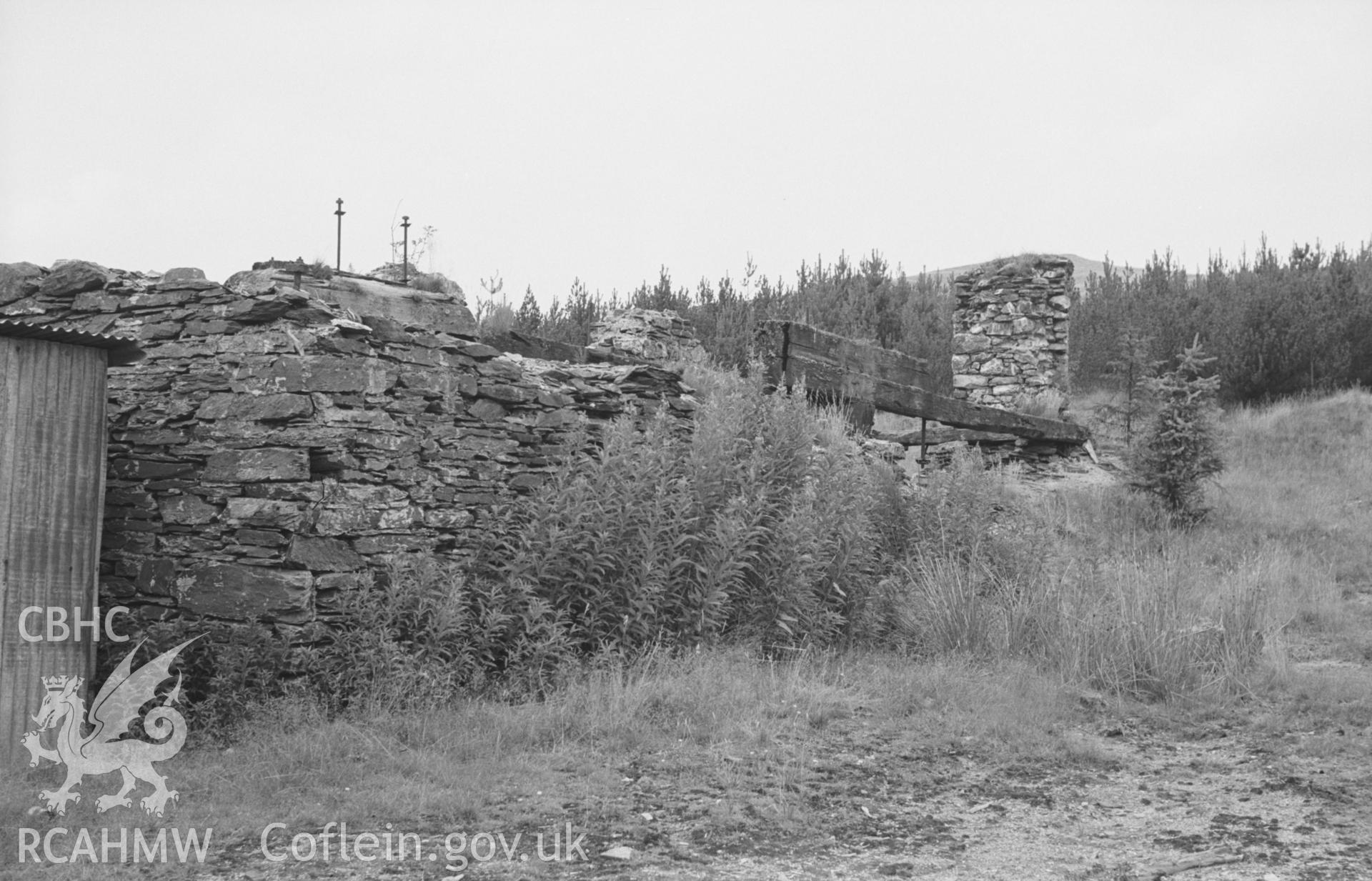 Digital copy of a black and white negative showing the wheel pit at Esgair Fraith lead mine. Photographed by Arthur O. Chater on 22nd August 1967, looking north west from Grid Reference SN 740 912.