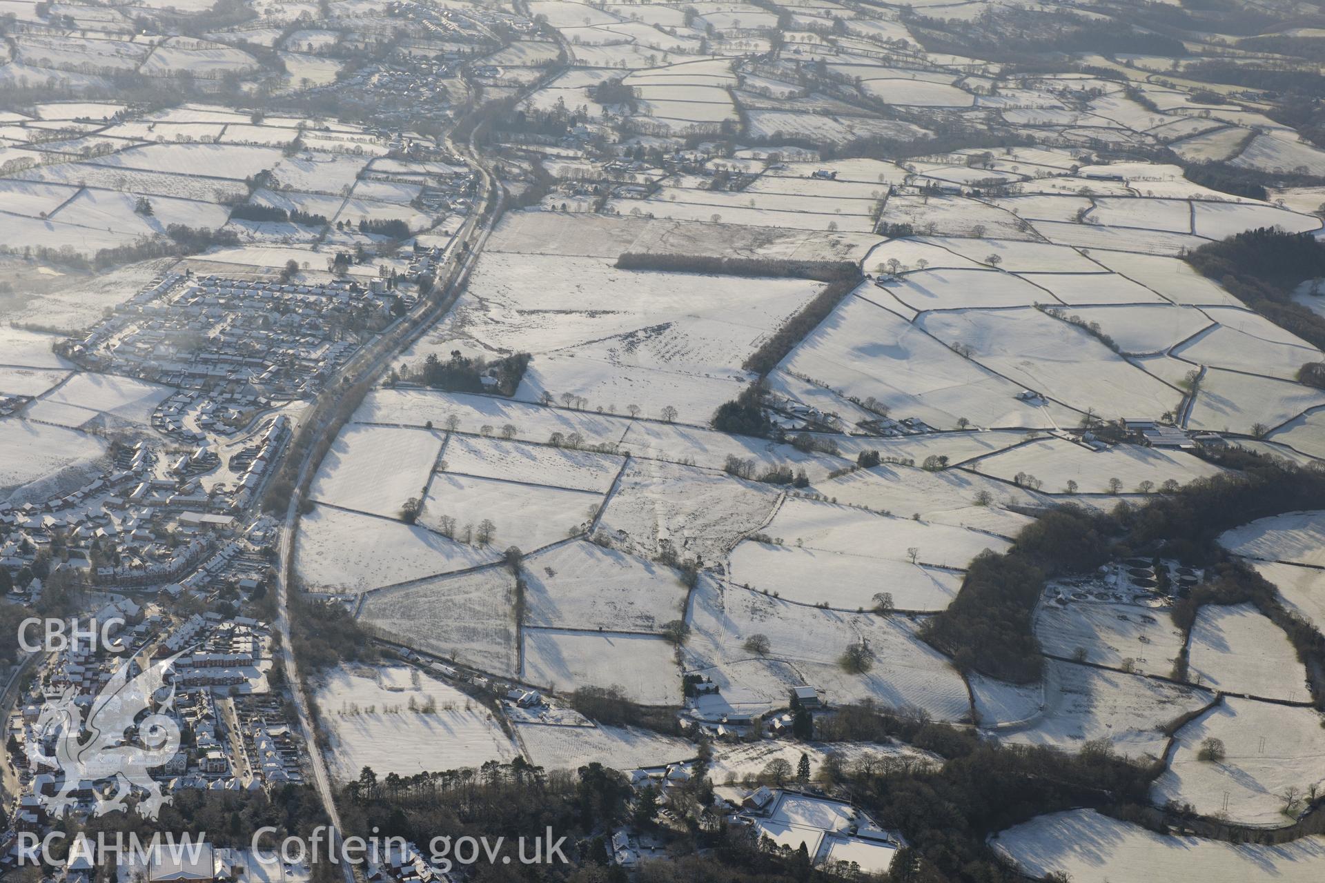 Roman camps and the Roman road on Llandrindod Common, with the town on the left of the photograph. Oblique aerial photograph taken during the Royal Commission?s programme of archaeological aerial reconnaissance by Toby Driver on 15th January 2013.