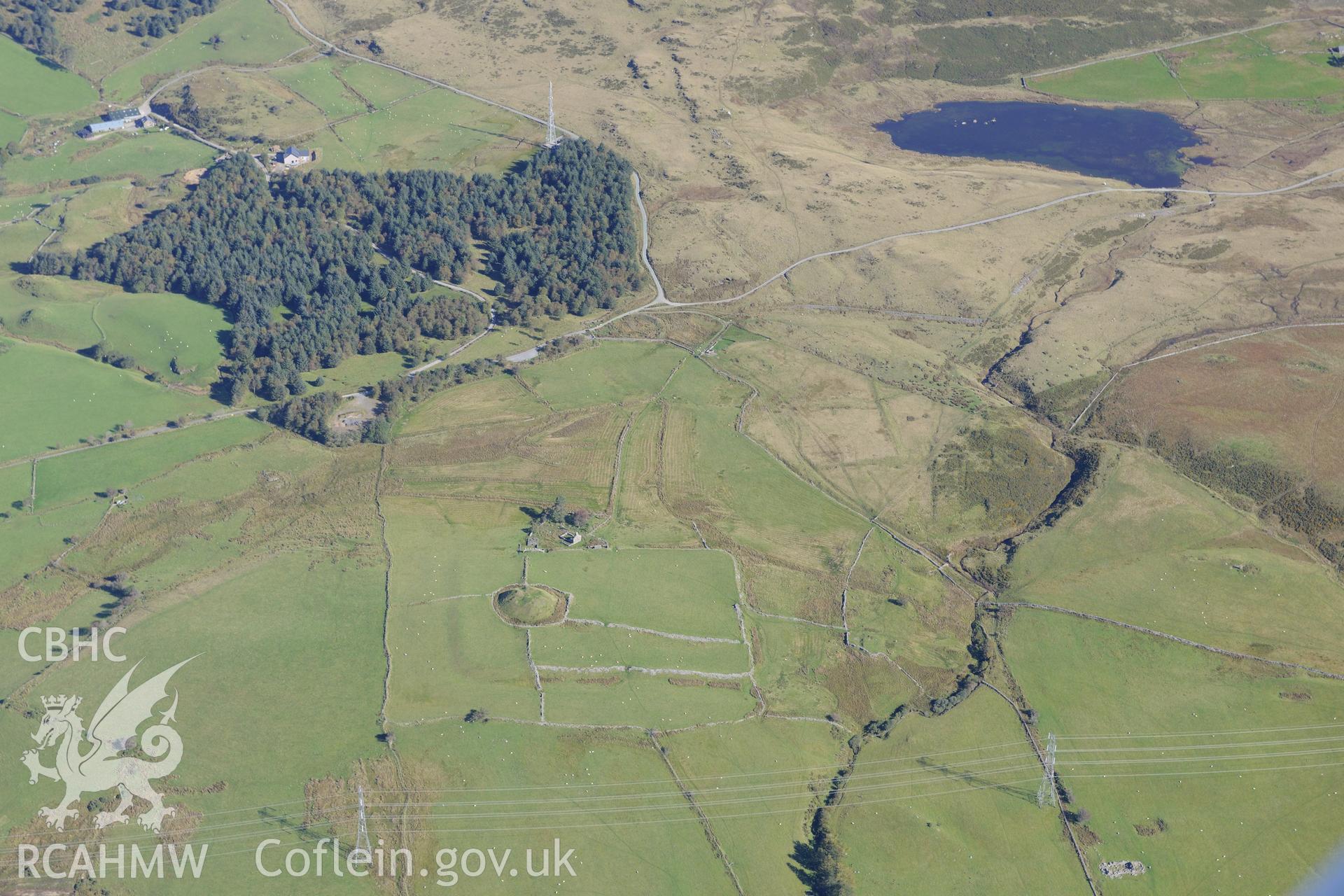 Tomen y Mur castell, Tomen y Mur roman fort and Tomen y Mur farm. Oblique aerial photograph taken during the Royal Commission's programme of archaeological aerial reconnaissance by Toby Driver on 2nd October 2015.