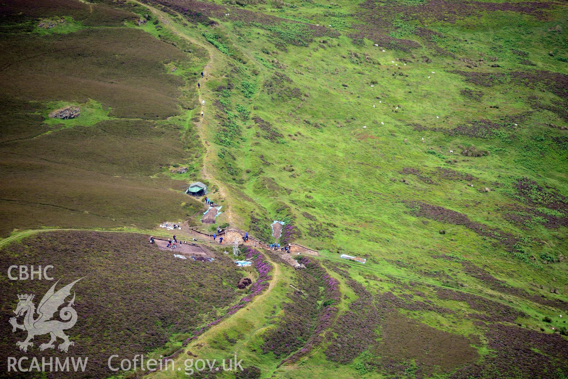 Penycloddiau Hilfort and Hut Platform V, Llangwyfan. Excavation by Liverpool University. Oblique aerial photograph taken during the Royal Commission's programme of archaeological aerial reconnaissance by Toby Driver on 30th July 2015.