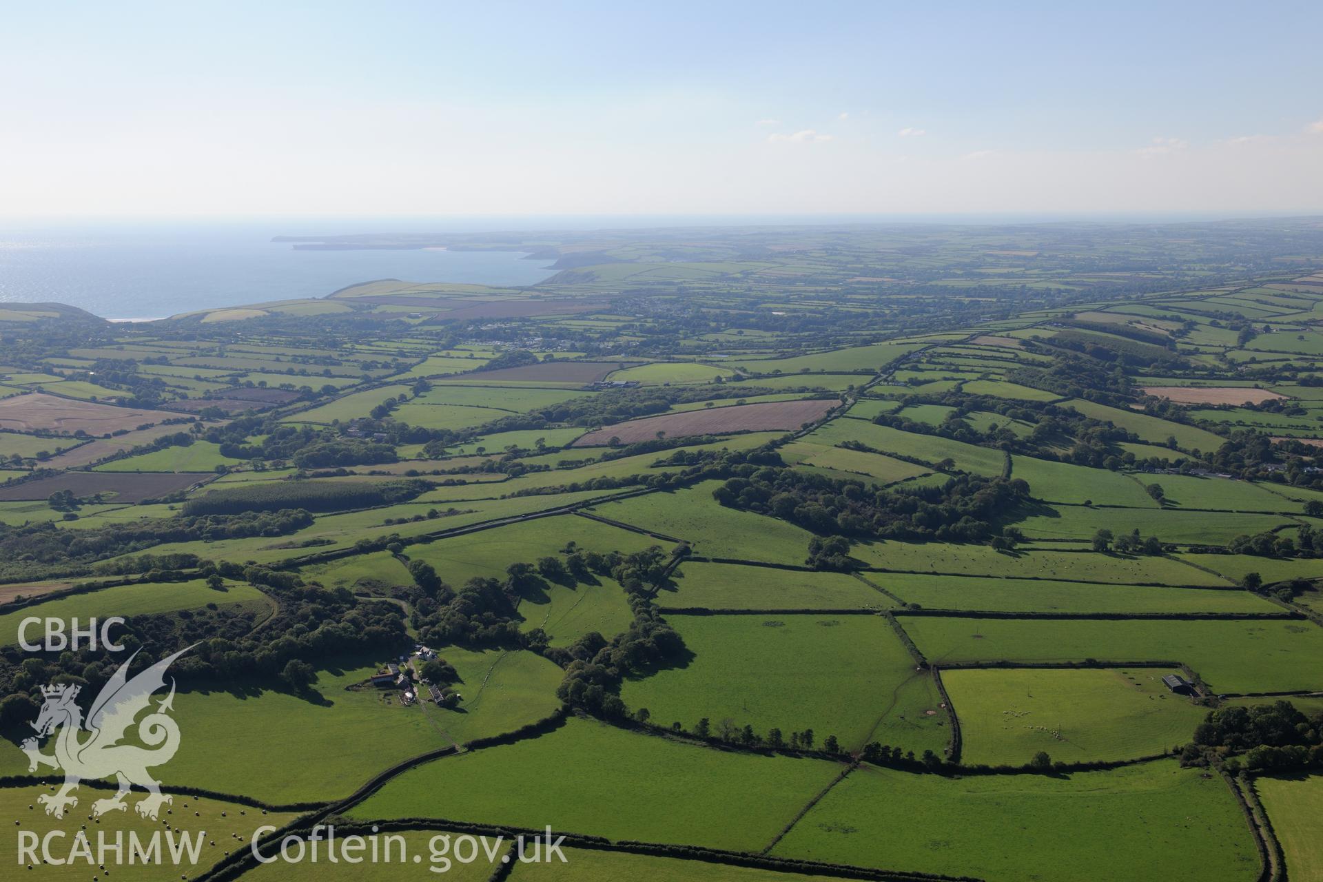 View of Palmerslake farm, Penally, west of Tenby, looking towards the south Wales coast. Oblique aerial photograph taken during the Royal Commission's programme of archaeological aerial reconnaissance by Toby Driver on 30th September 2015.