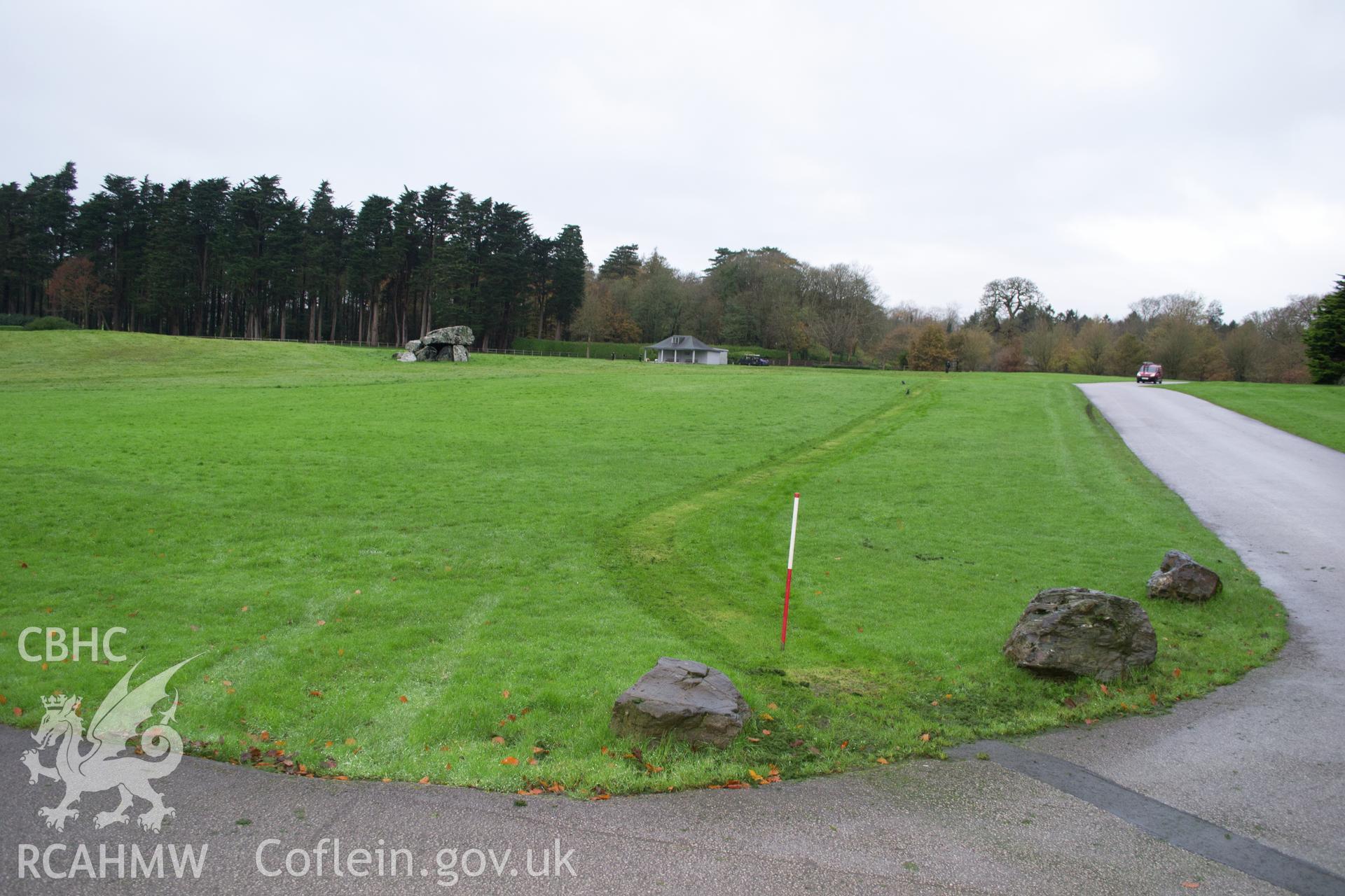 General view from north east showing cable route with stables behind, & burial & pavilion in the background. Photographed during archaeological watching brief of Plas Newydd, Ynys Mon conducted by Gwynedd Archaeological Trust, 14/11/2017. Project no. 2542.