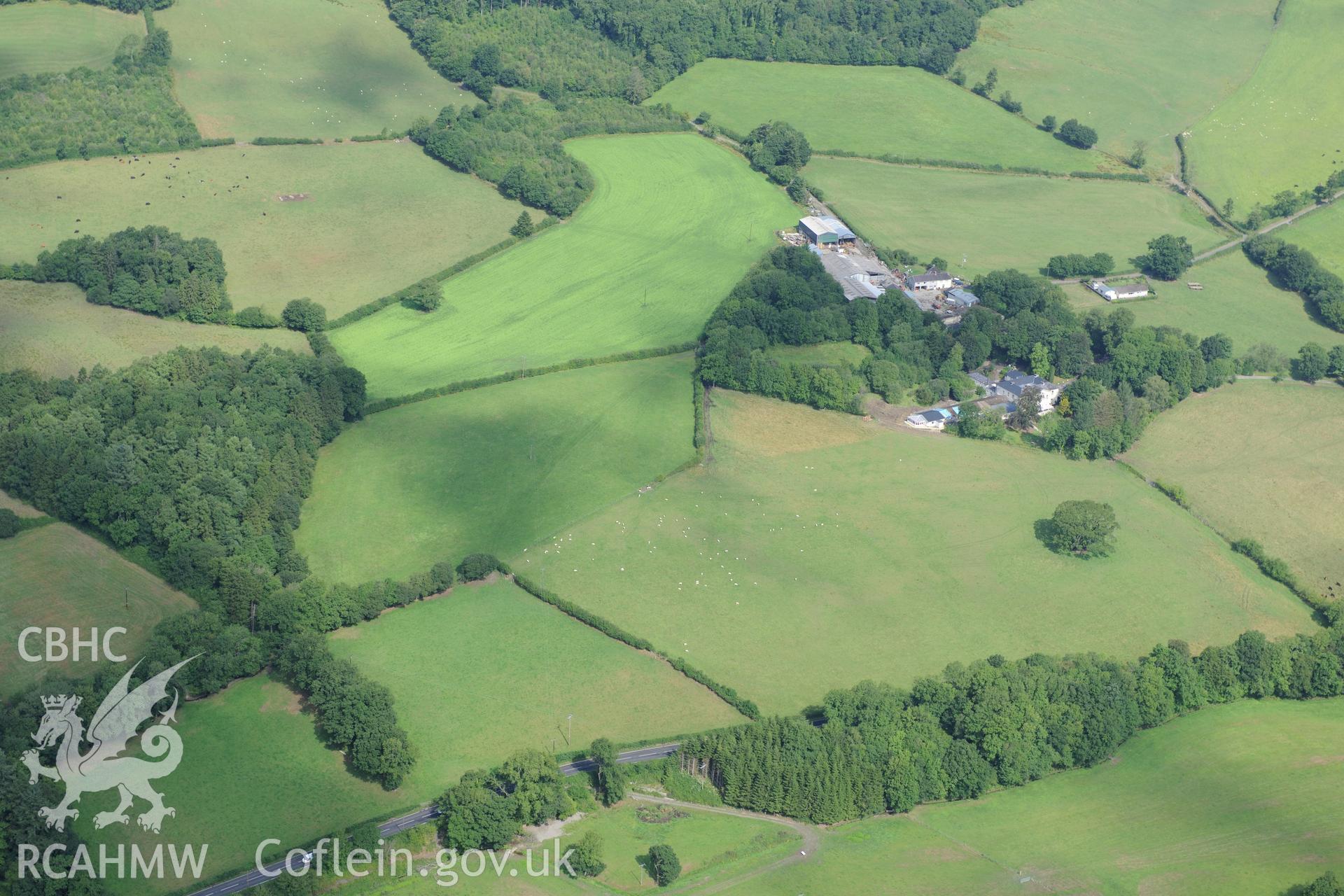 Blaenos Mansion and gardens, with Roman fortlet in diamond-shaped field immediately to the south west of the mansion and farm buildings. Oblique aerial photograph taken during the Royal Commission?s programme of archaeological aerial reconnaissance by Toby Driver on 1st August 2013.