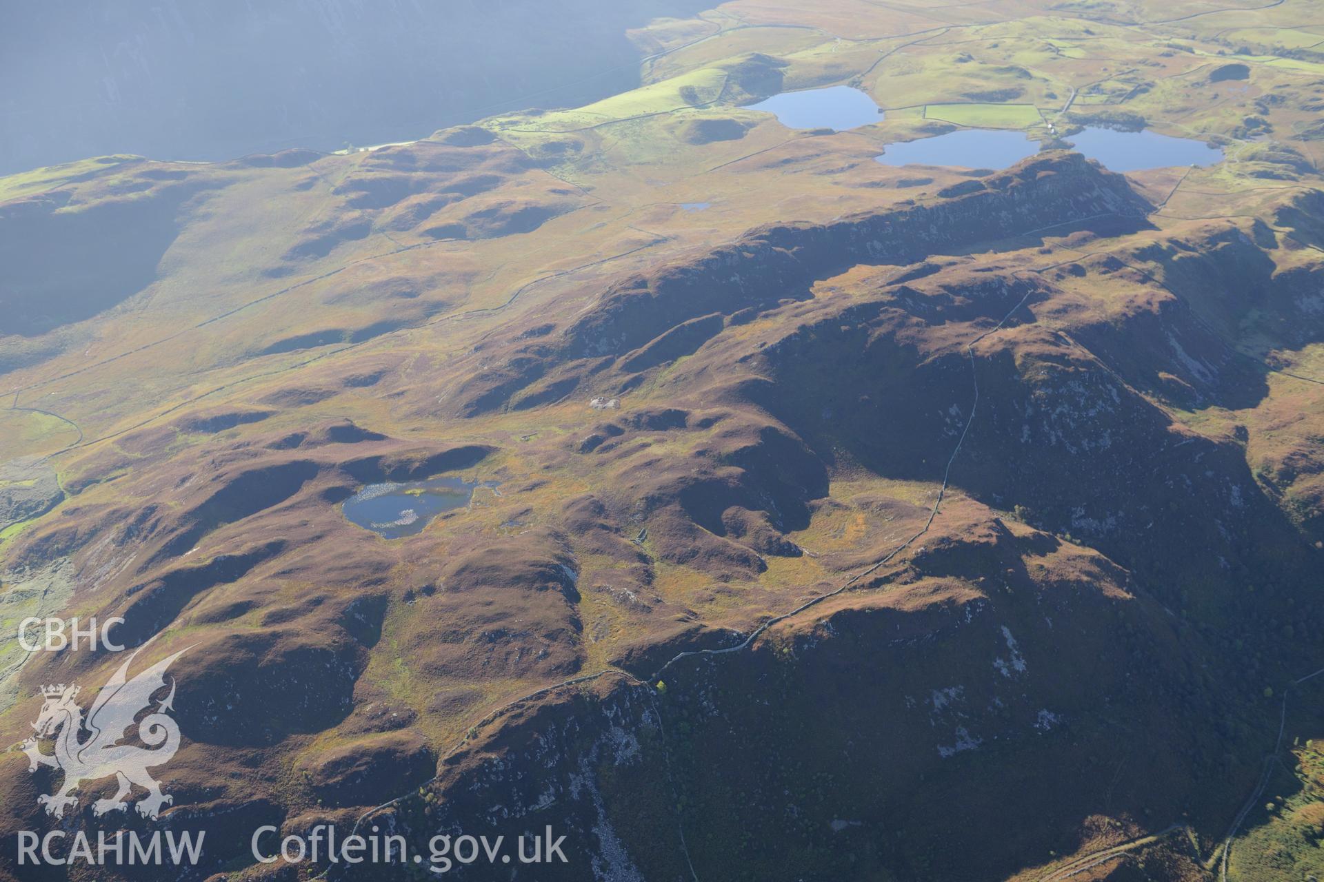 Pared y Cefnhir hillfort and Llynnau Cregennen, about halfway between Dolgellau and Fairbourne. Oblique aerial photograph taken during the Royal Commission's programme of archaeological aerial reconnaissance by Toby Driver on 2nd October 2015.