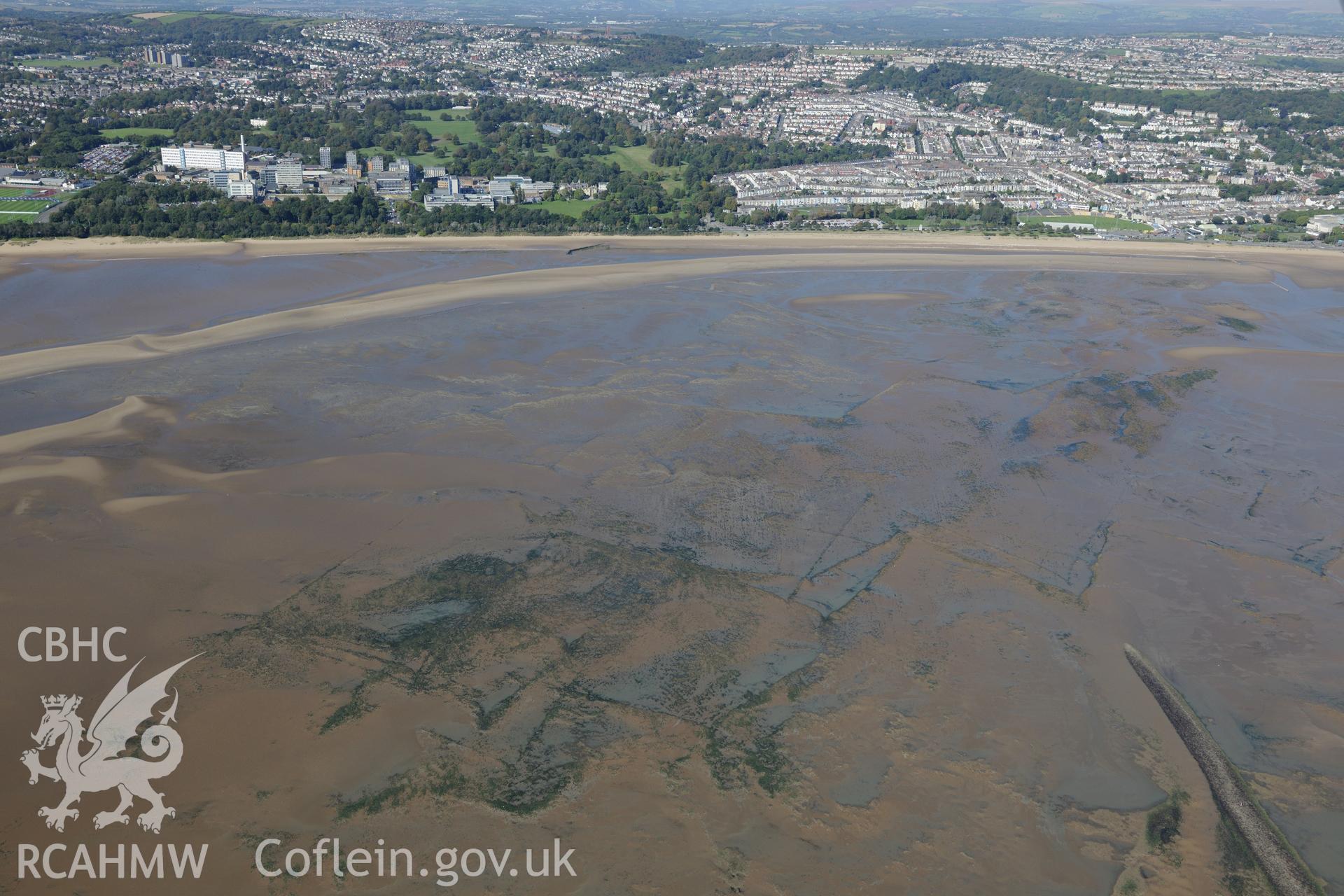 Fishtraps off the coast of Swansea Bay, with Swansea University and Swansea city beyond. Oblique aerial photograph taken during the Royal Commission's programme of archaeological aerial reconnaissance by Toby Driver on 30th September 2015.