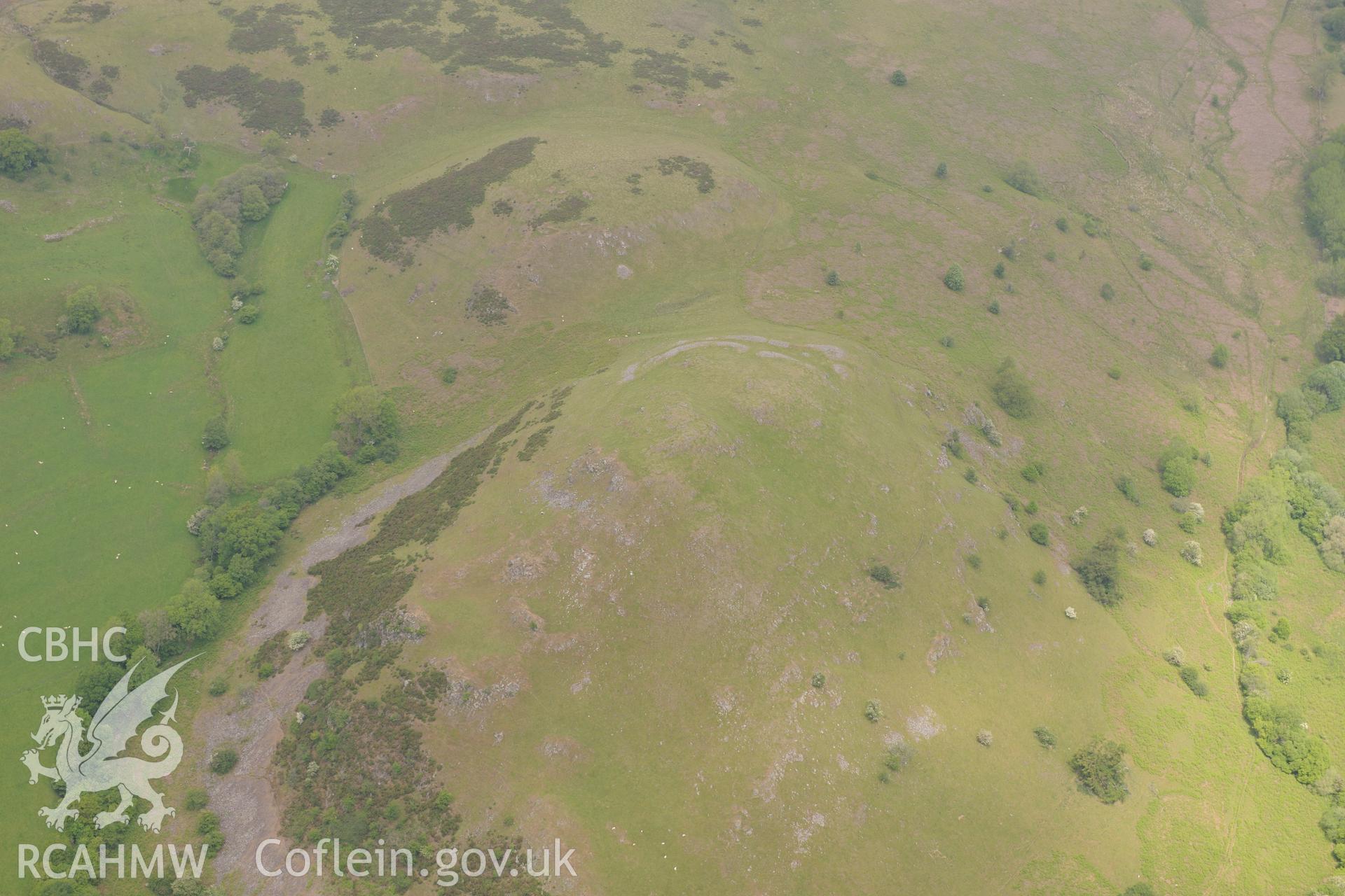 Caer Einion Hillfort and hut platforms I and III, Llanelwedd. Oblique aerial photograph taken during the Royal Commission's programme of archaeological aerial reconnaissance by Toby Driver on 11th June 2015.