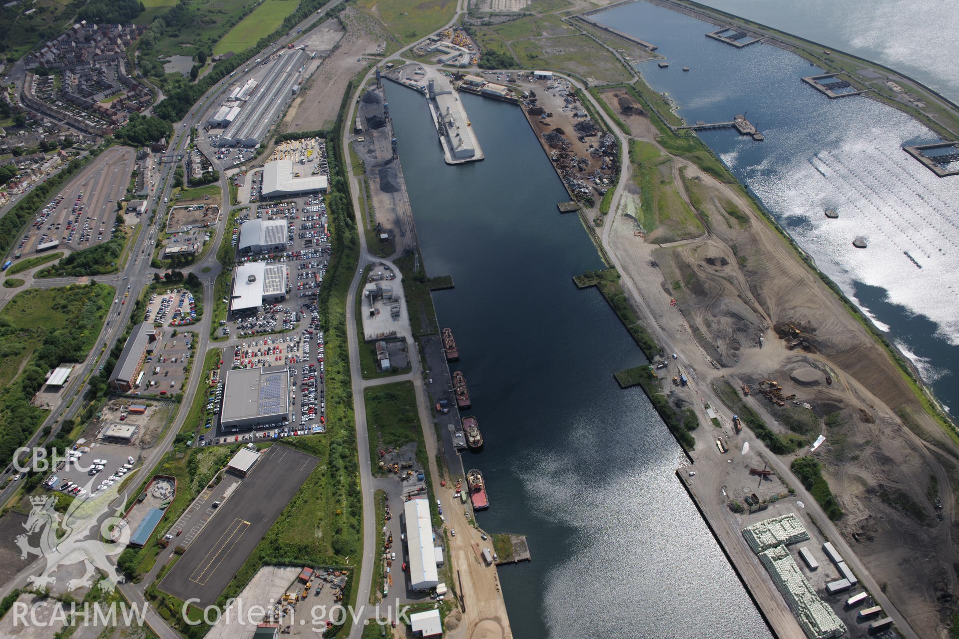 Workshops around the King's and Queen's docks at Swansea Docks. Oblique aerial photograph taken during the Royal Commission's programme of archaeological aerial reconnaissance by Toby Driver on 19th June 2015.