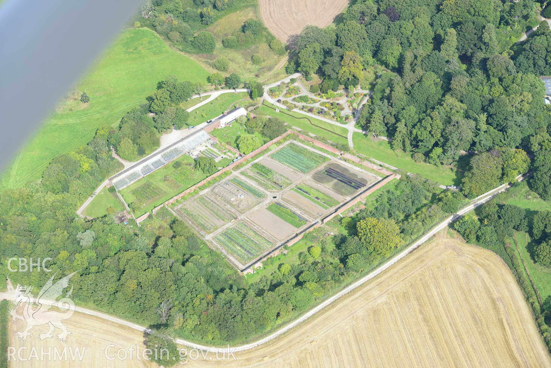 Mostyn Hall - the main block, the stables, the barn and mill and the park and gardens, Mostyn. Oblique aerial photograph taken during the Royal Commission's programme of archaeological aerial reconnaissance by Toby Driver on 11th September 2015.