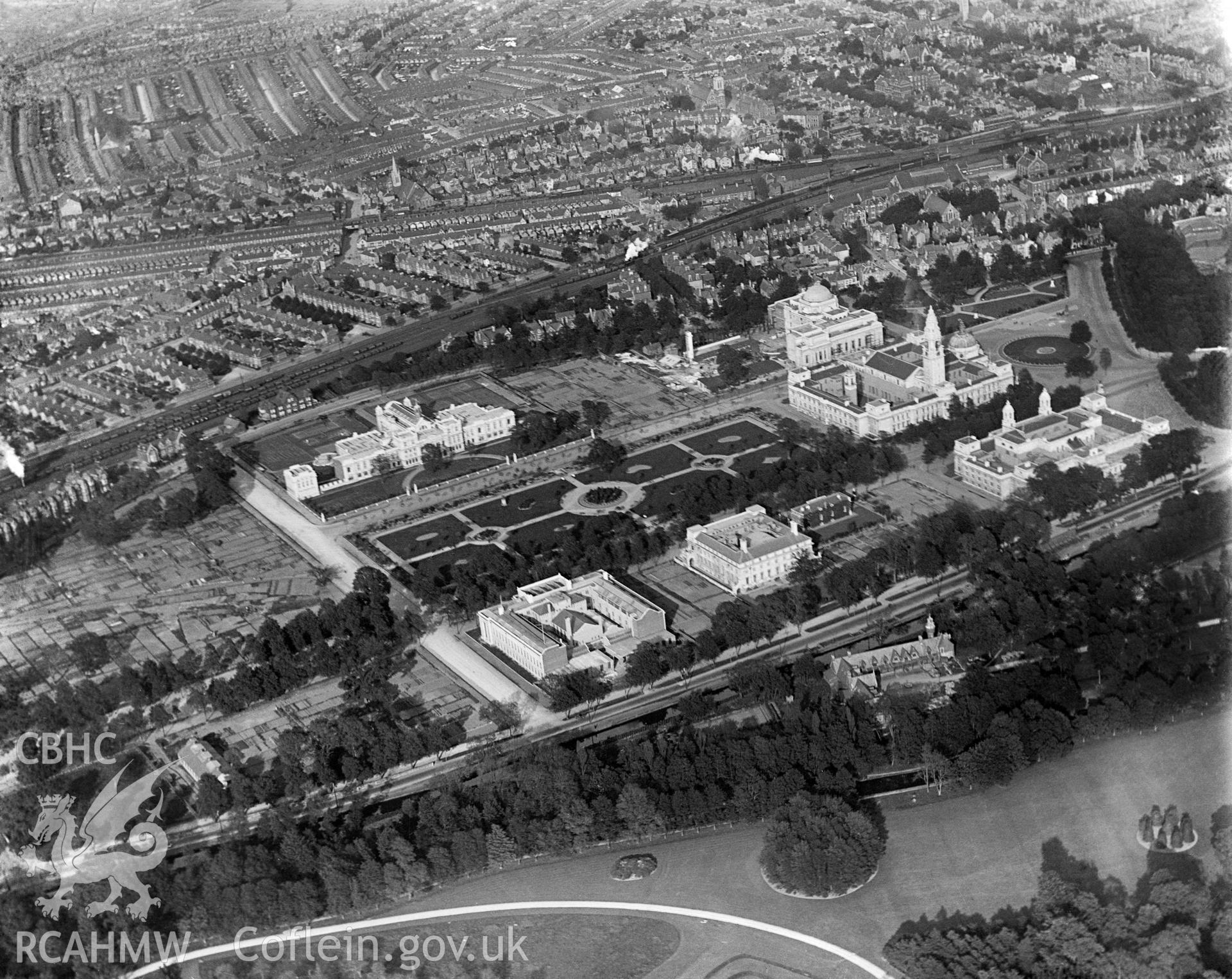 Digital copy of a black and white, oblique aerial photograph of Cardiff Civic Centre. The photograph shows the view from the West. Note the allotment gardens on the left side of the photograph over which further development of the Civic Centre building was to take place in the 1930s.