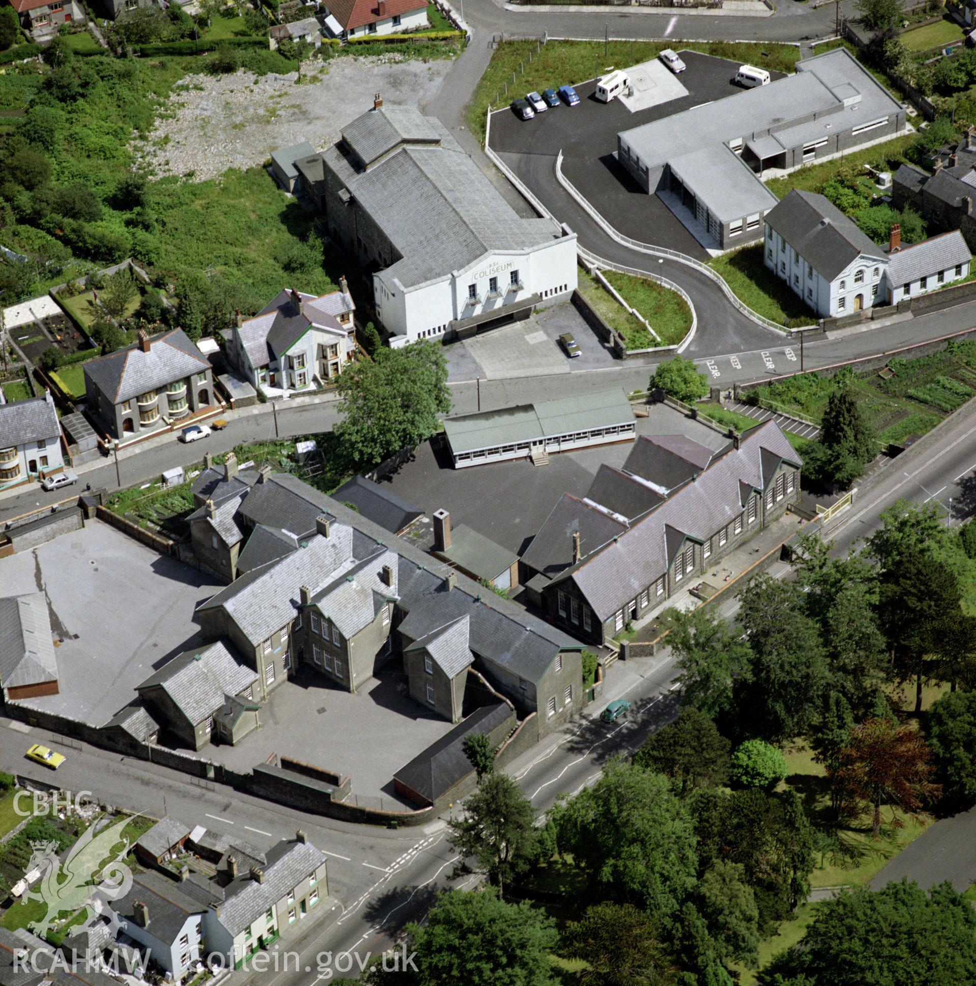 Digital copy of a colour oblique aerial photograph of the Coliseum, Trecynon. The photograph shows a view from the West, before extensive remodelling and extension and its subsequent reopening as a theatre in the 1990s.