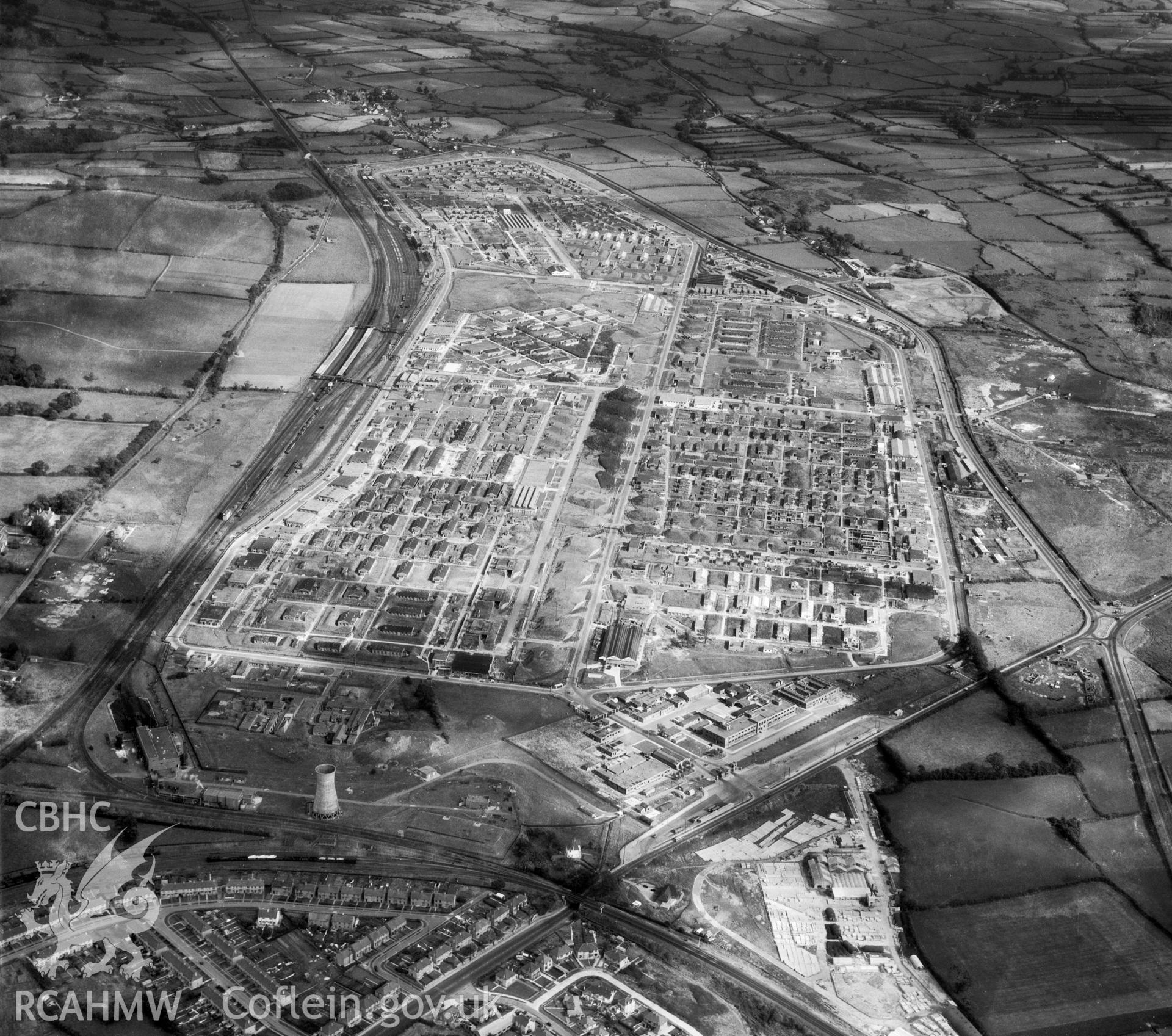 Digital copy of a black and white, oblique aerial photograph of Bridgend Royal Ordnance factory, Glamorgan. The photograph shows a view from the West showing the site with all ordnance production facilities intact immediately prior to the conversion of the site to a trading estate.