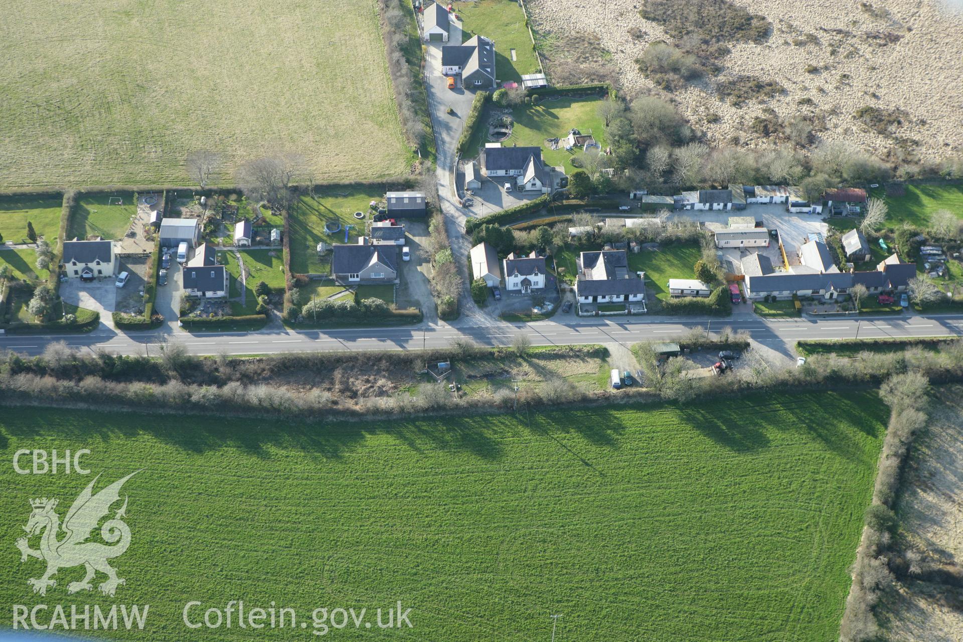 RCAHMW colour oblique aerial photograph of two round barrows southeast  of Goodwins Row, Efailwen. Taken on 13 April 2010 by Toby Driver