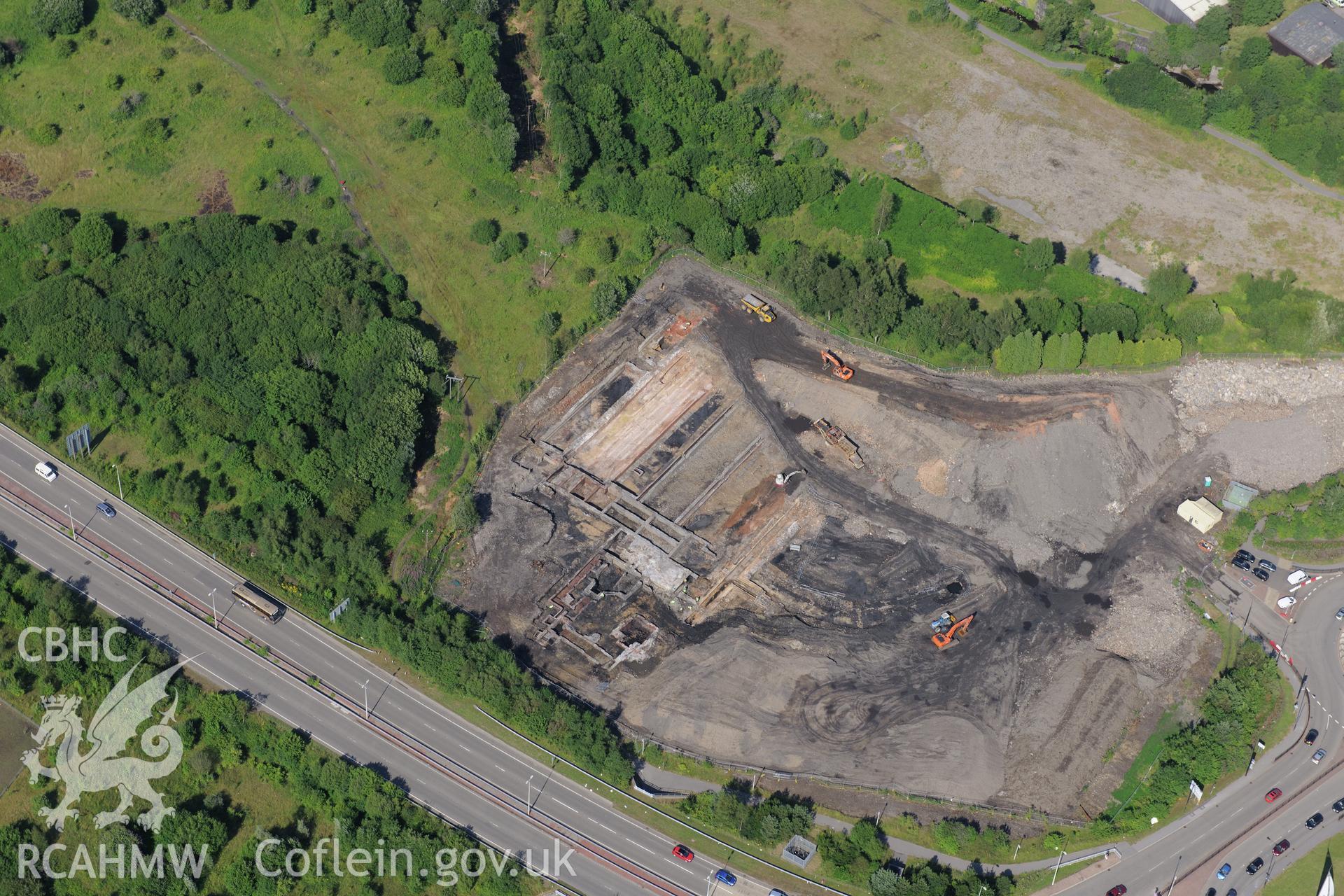 Site of former Rotax factory, Cyfarthfa Retail Park, and Cyfarthfa Ironworks including the remains of its blast furnaces, under excavation by Glamorgan-Gwent Archaeological Trust. Oblique aerial photograph taken during the Royal Commission?s programme of