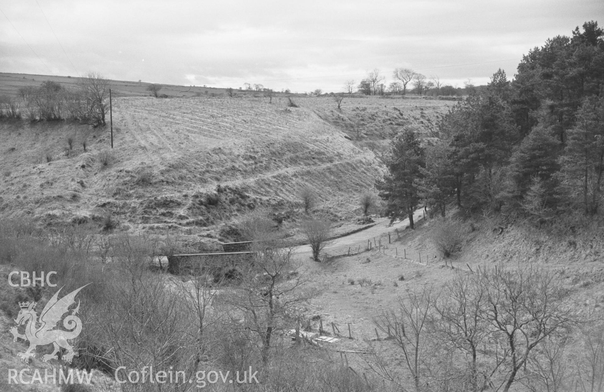 Digital copy of a black and white negative showing bridge over the Afon Grannell just below Moeddyn-Fach farm, from the overgrown track to Felin-Blaenau. Photographed by Arthur O. Chater in April 1965 from Grid Reference SN 4753 5123, looking west.