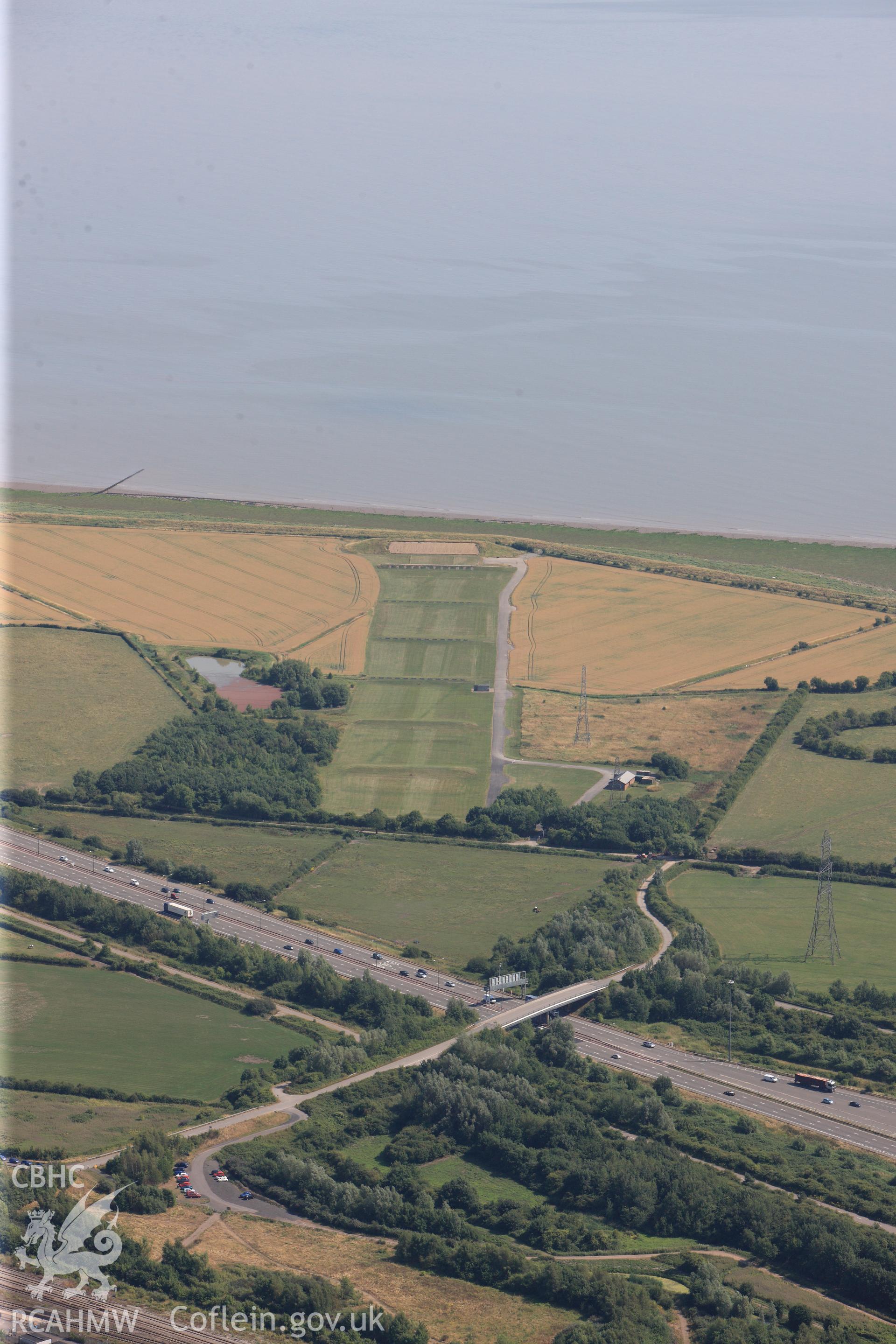 Rogiet Rifle range & section of the M4 motorway running along southern edge of Caldicot, on its way to the Second Severn Crossing. Oblique aerial photograph taken during RCAHMW?s programme of archaeological aerial reconnaissance by Toby Driver, 1 Aug 2013.