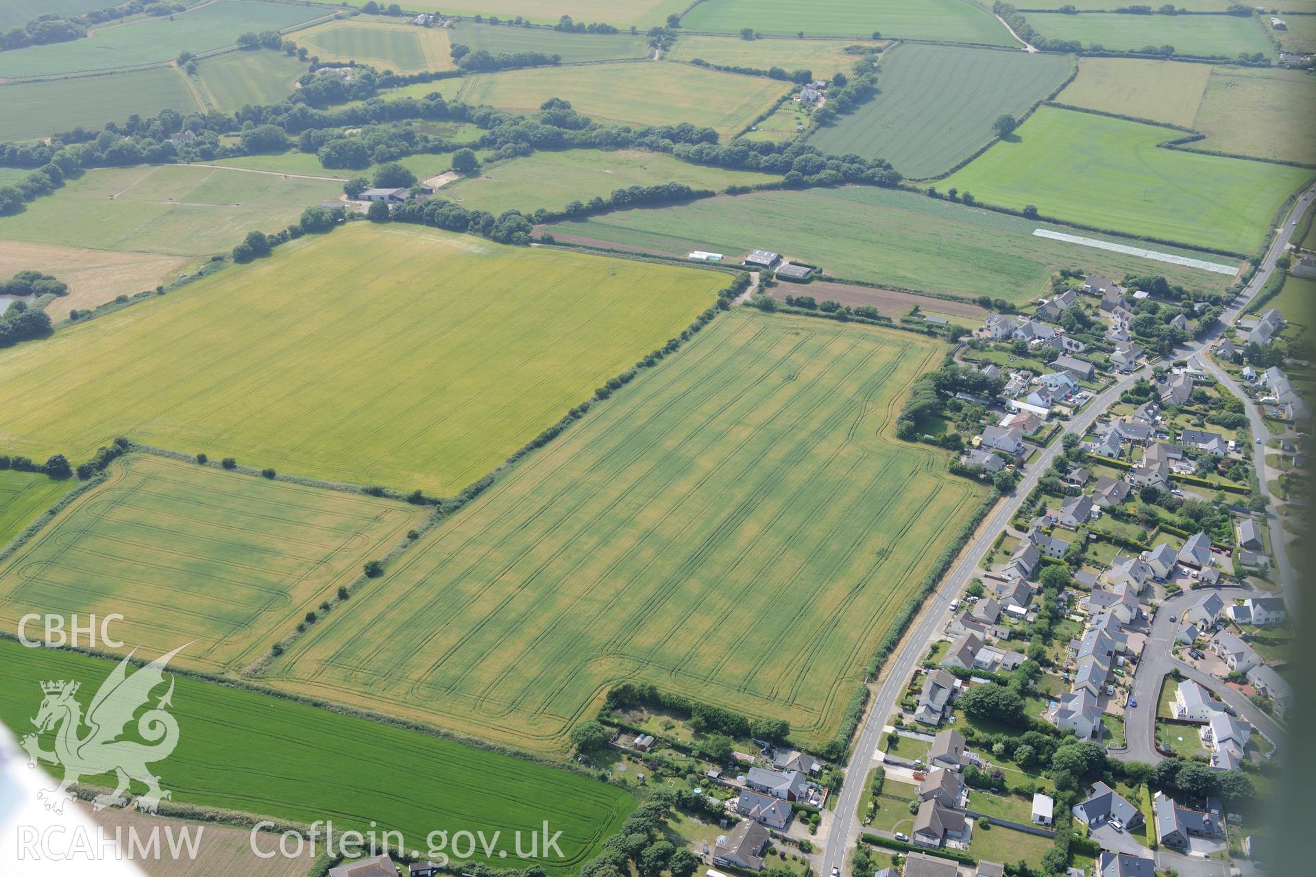 Hearson Farm defended enclosures, Hill Mountain, north east of Milford Haven. Oblique aerial photograph taken during the Royal Commission?s programme of archaeological aerial reconnaissance by Toby Driver on 16th July 2013.