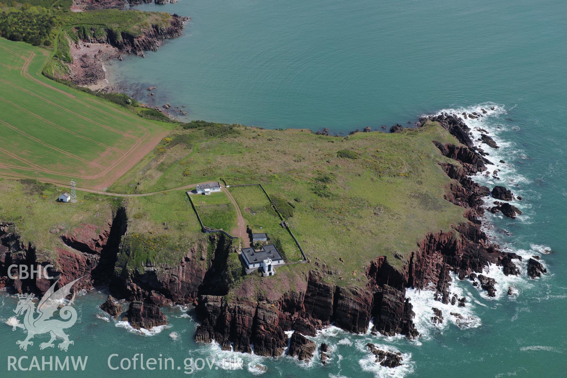 Great Castle Head promontory fort and Leading Lights, a summer house near St. Ishmaels. Oblique aerial photograph taken during the Royal Commission's programme of archaeological aerial reconnaissance by Toby Driver on 13th May 2015.