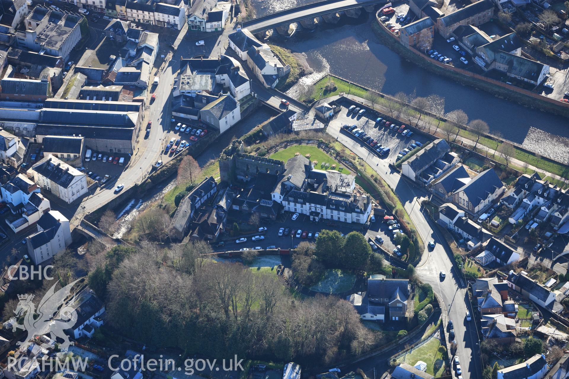 Brecon Castle and the Castle of Brecon Hotel. Oblique aerial photograph taken during the Royal Commission?s programme of archaeological aerial reconnaissance by Toby Driver on 15th January 2013.