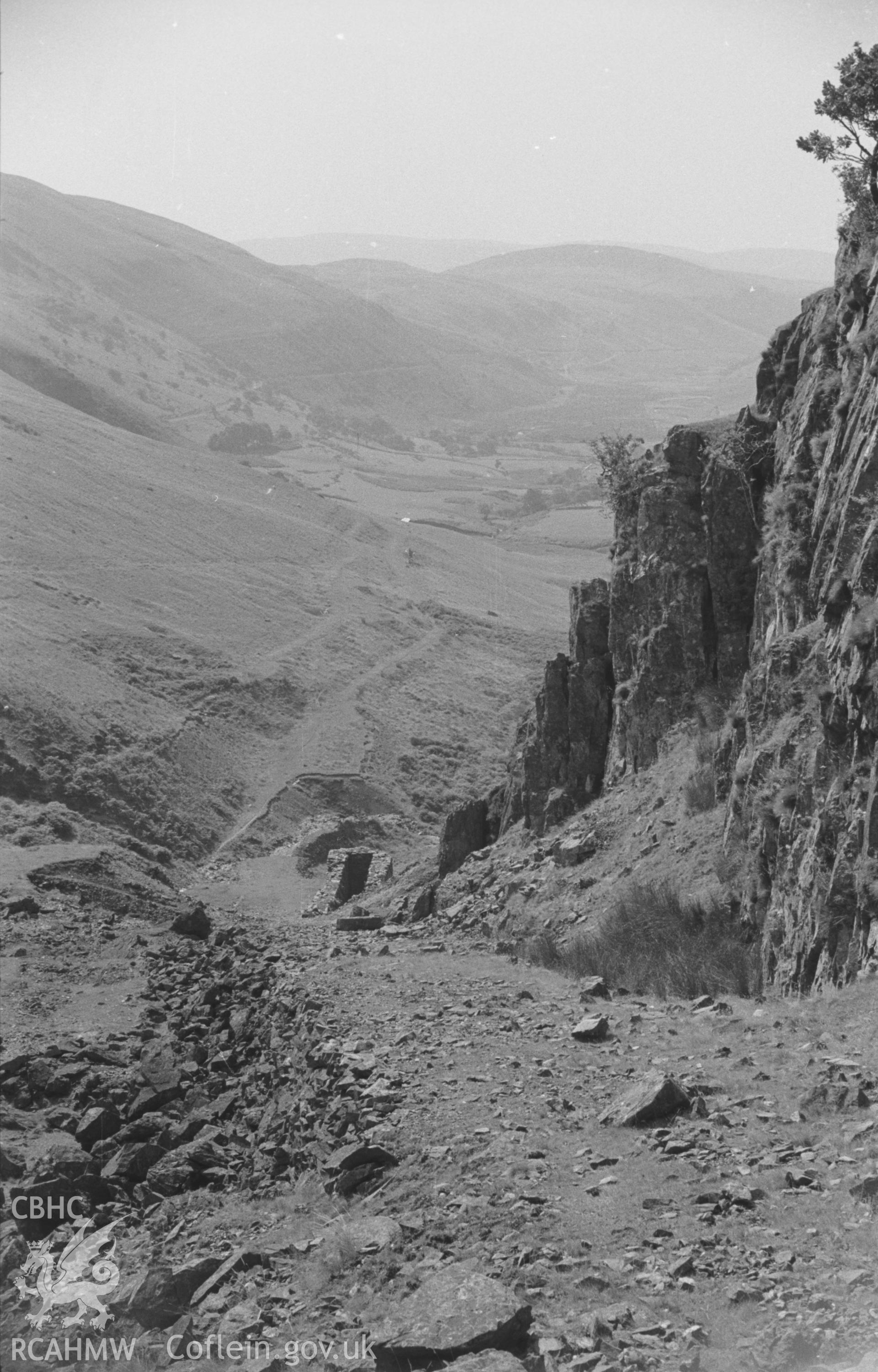 Digital copy of a black and white negative looking down the incline of the Plynlimon and Hafan Tramway. Wheelpit of mine in centre. Photographed by Arthur O. Chater in August 1965 from Grid Reference SN 7393 8795, looking east.