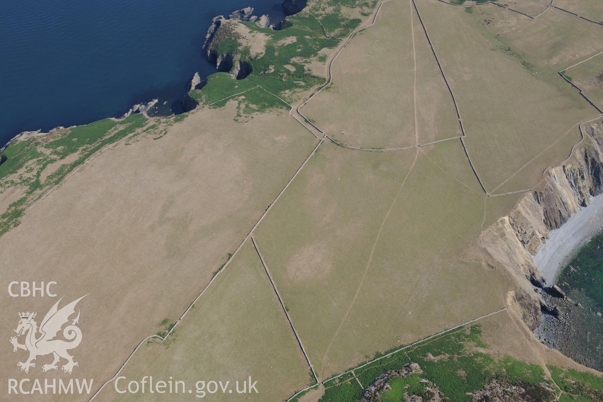 Parc y Capel round barrow I on Ramsey Island. Oblique aerial photograph taken during the Royal Commission?s programme of archaeological aerial reconnaissance by Toby Driver on 16th July 2013.