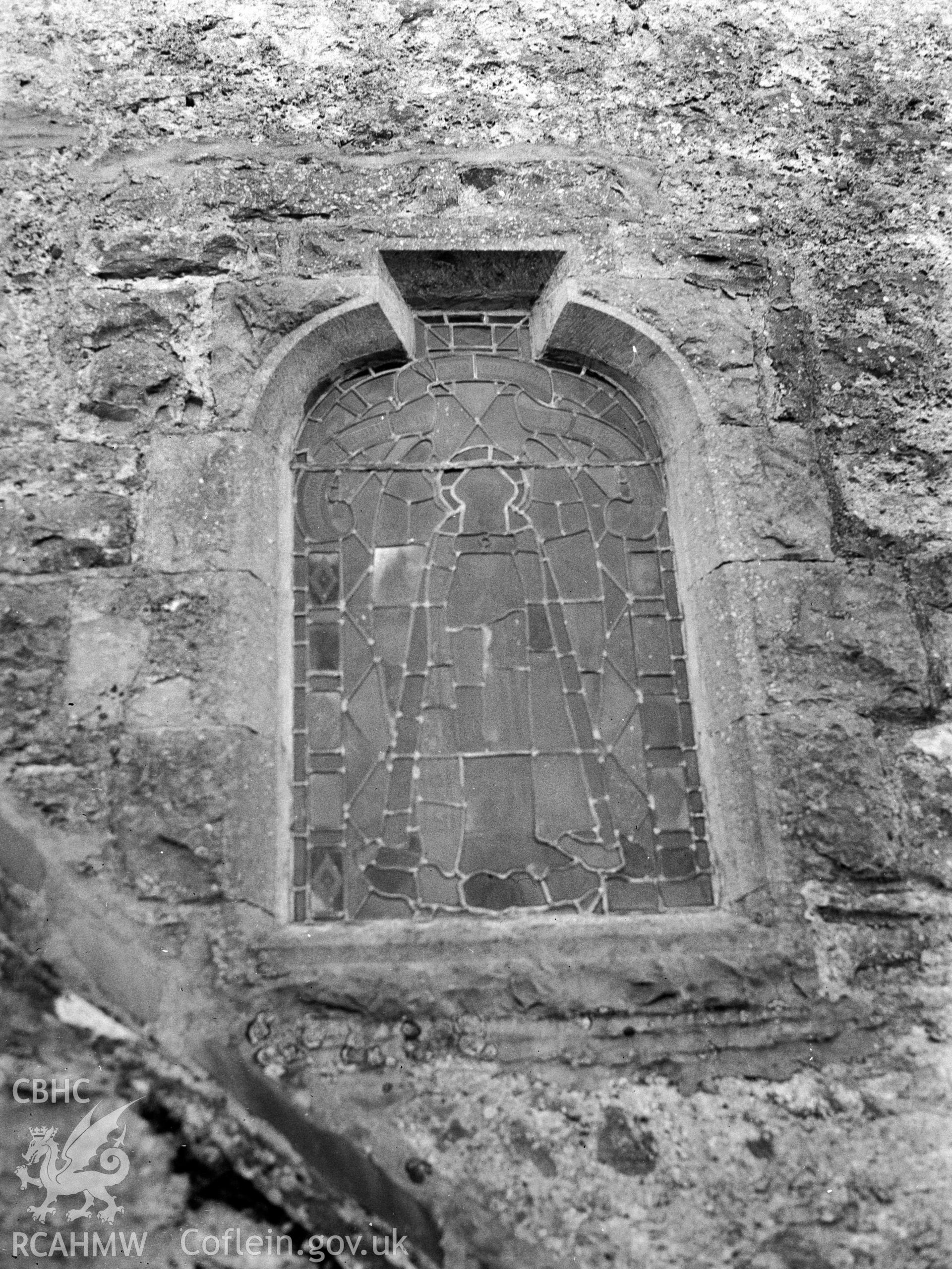 Digital copy of a nitrate negative showing exterior view of detail of stained glass window, St James's Church,  Manorbier. From the National Building Record Postcard Collection.