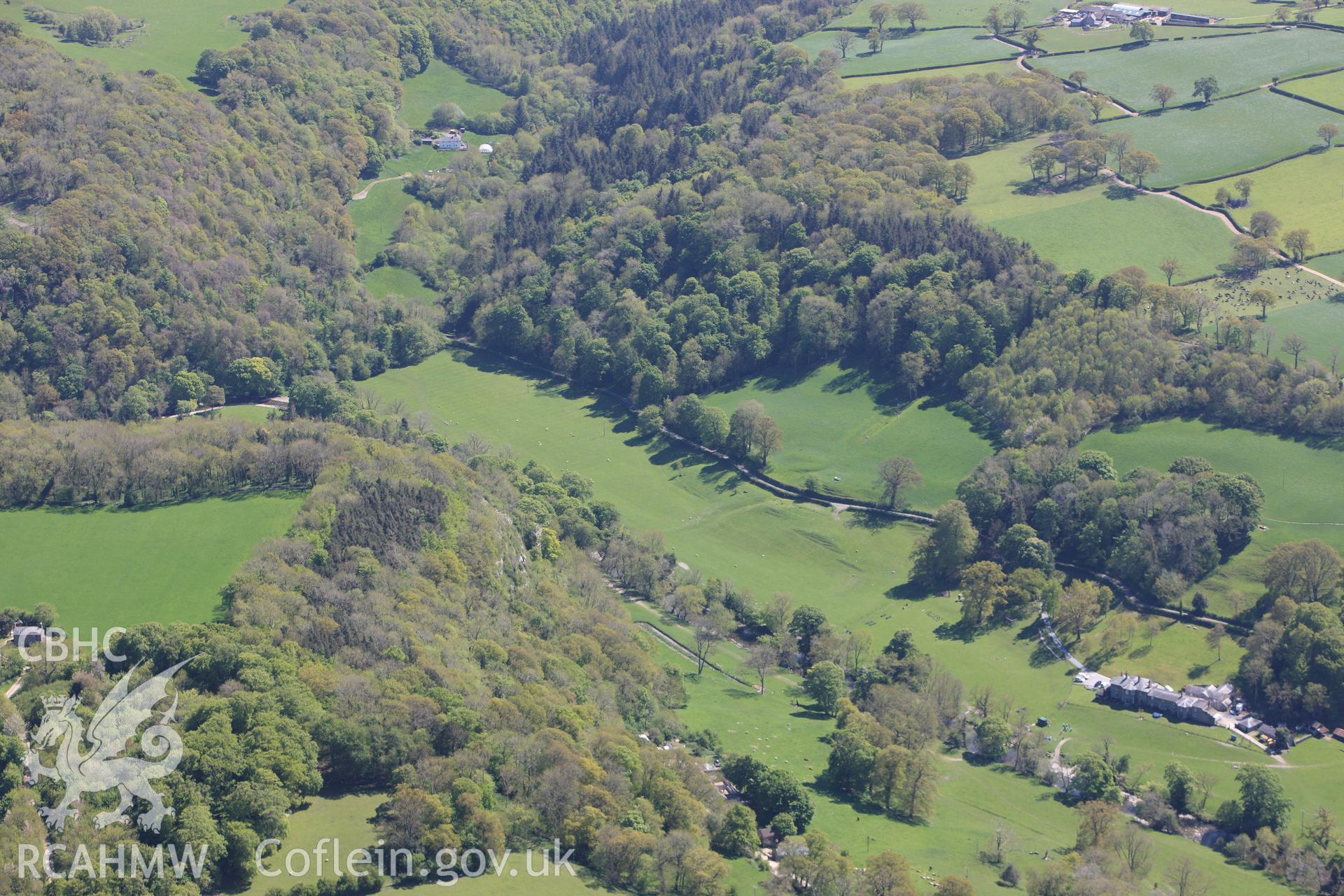 Bont Newydd Cave in it's landscape. Oblique aerial photograph taken during the Royal Commission?s programme of archaeological aerial reconnaissance by Toby Driver on 22nd May 2013.