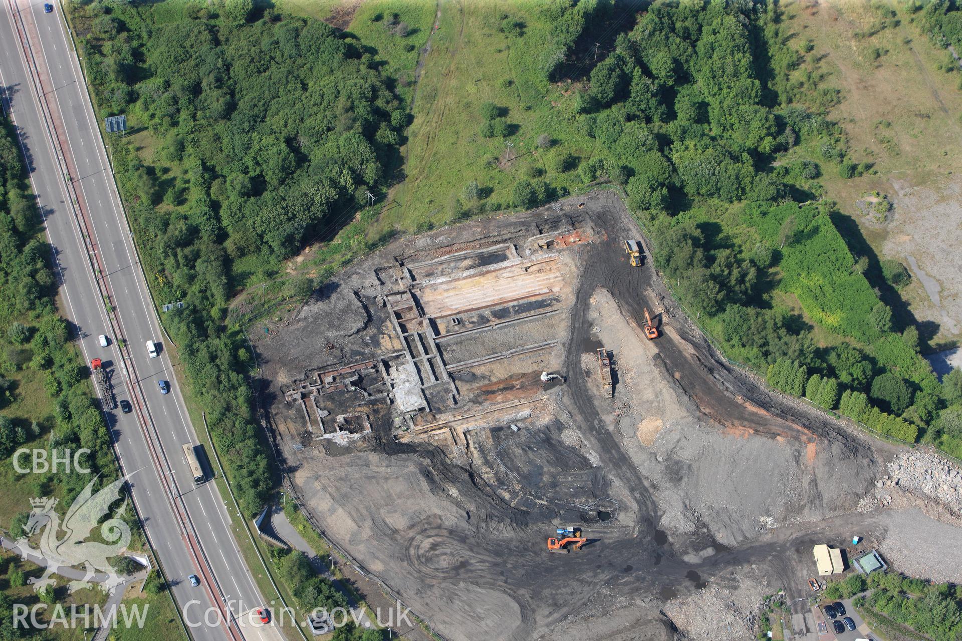 Site of former Rotax factory, and Cyfarthfa Ironworks including the remains of its blast furnaces, under excavation by Glamorgan-Gwent Archaeological Trust. Oblique aerial photograph taken during the Royal Commission?s programme of archaeological aerial reconnaissance by Toby Driver on 1st August 2013.