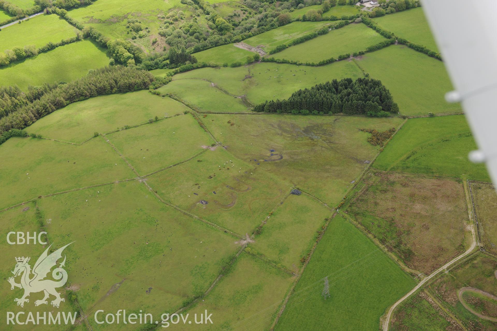 Cructarw round barrow, Llangeler. Oblique aerial photograph taken during the Royal Commission's programme of archaeological aerial reconnaissance by Toby Driver on 3rd June 2015.