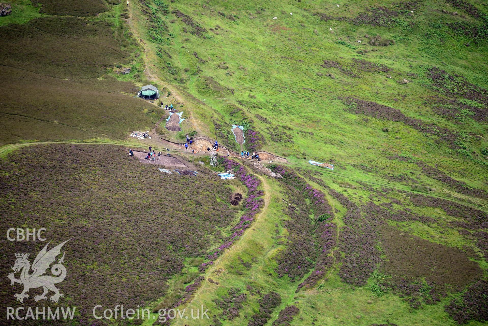 Penycloddiau Hilfort and Hut Platform V, Llangwyfan. Excavation by Liverpool University. Oblique aerial photograph taken during the Royal Commission's programme of archaeological aerial reconnaissance by Toby Driver on 30th July 2015.