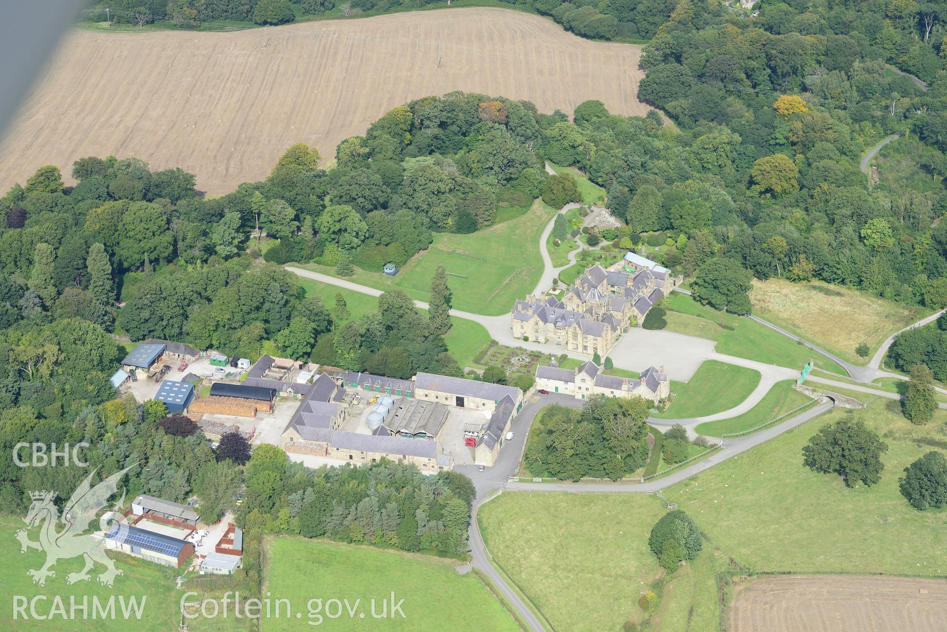 Mostyn Hall - the main block, the stables, the barn and mill and the park and gardens, Mostyn. Oblique aerial photograph taken during the Royal Commission's programme of archaeological aerial reconnaissance by Toby Driver on 11th September 2015.