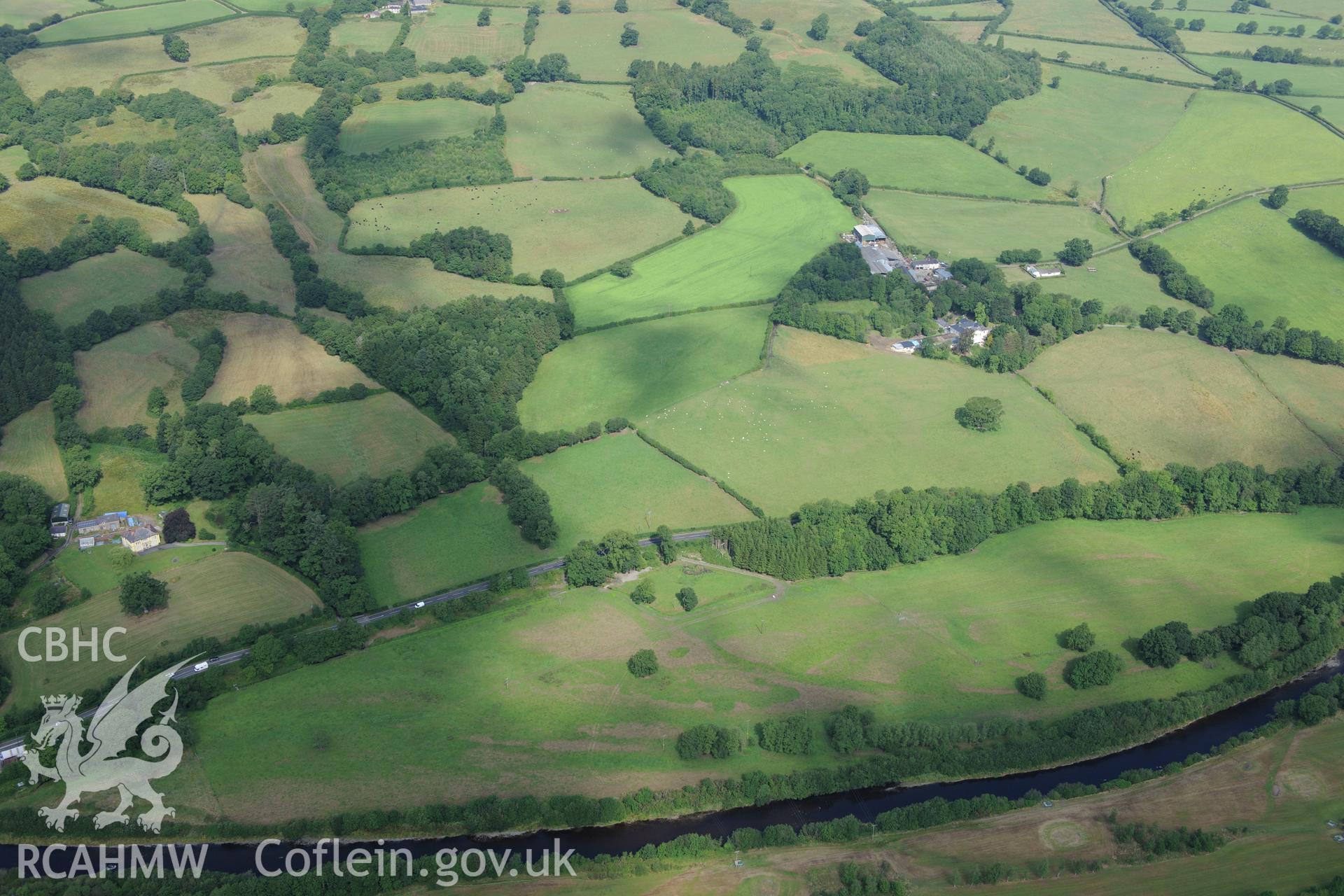 Blaenos Mansion and gardens, with Roman fortlet in diamond-shaped field immediately to the south west of the mansion and farm buildings. Oblique aerial photograph taken during the Royal Commission?s programme of archaeological aerial reconnaissance by Toby Driver on 1st August 2013.