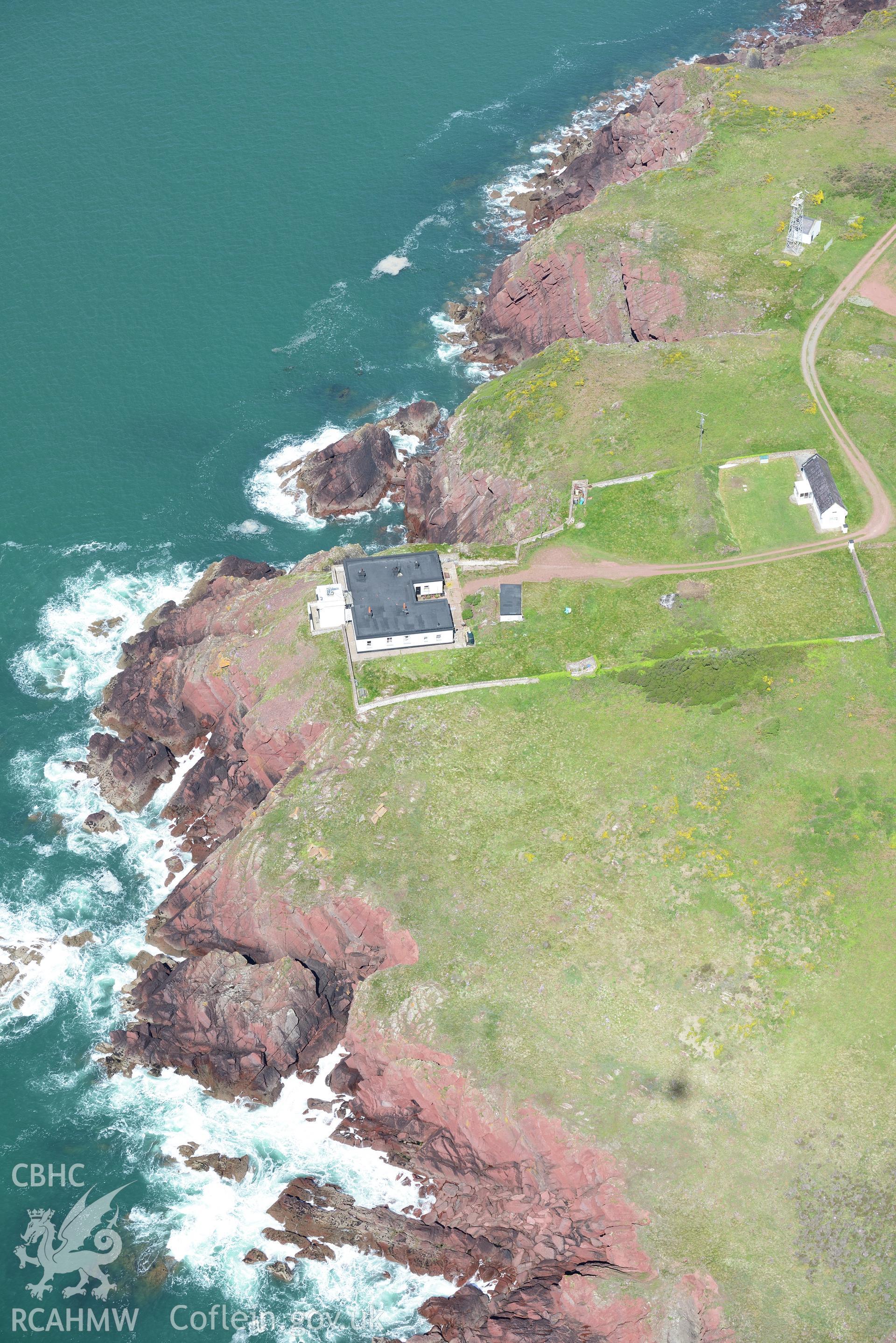 Great Castle Head promontory fort or defended enclosure, and Leading Lights summer house near St. Ishmaels. Oblique aerial photograph taken during the Royal Commission's programme of archaeological aerial reconnaissance by Toby Driver on 13th May 2015.